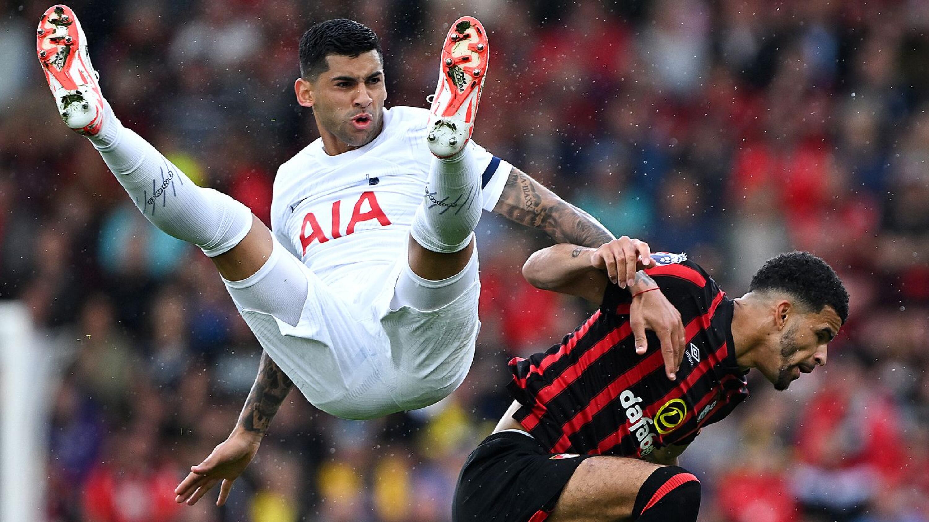 Tottenham Hotspur's Argentinian defender Cristian Romero (left) challenges Bournemouth's English striker Dominic Solanke during the English Premier League football match at the Vitality Stadium in Bournemouth, southern England