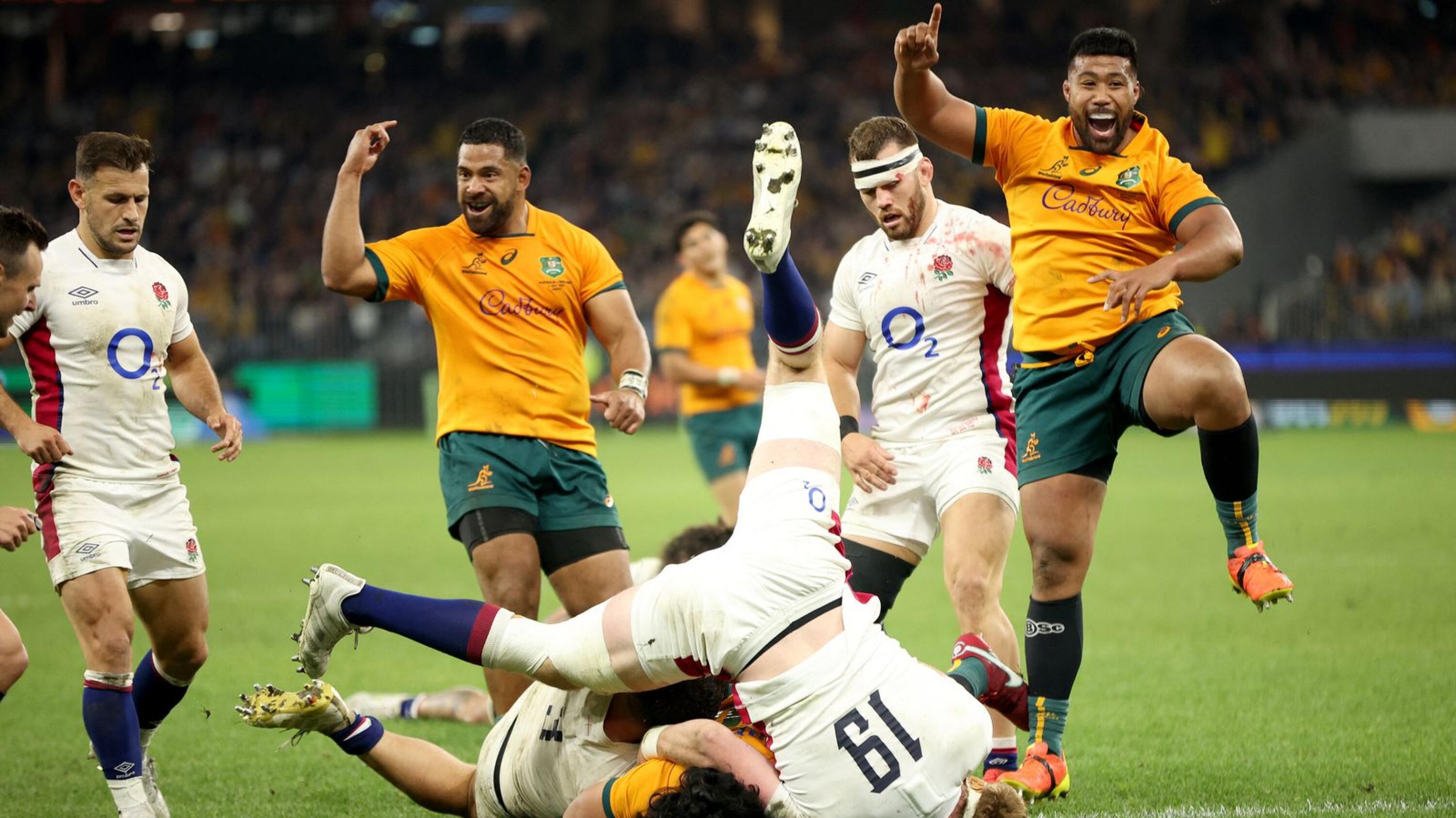 Folau Fainga’a (R) of Australia celebrates as a try is scored during the rugby test match against England at the Optus Stadium in Perth on Saturday