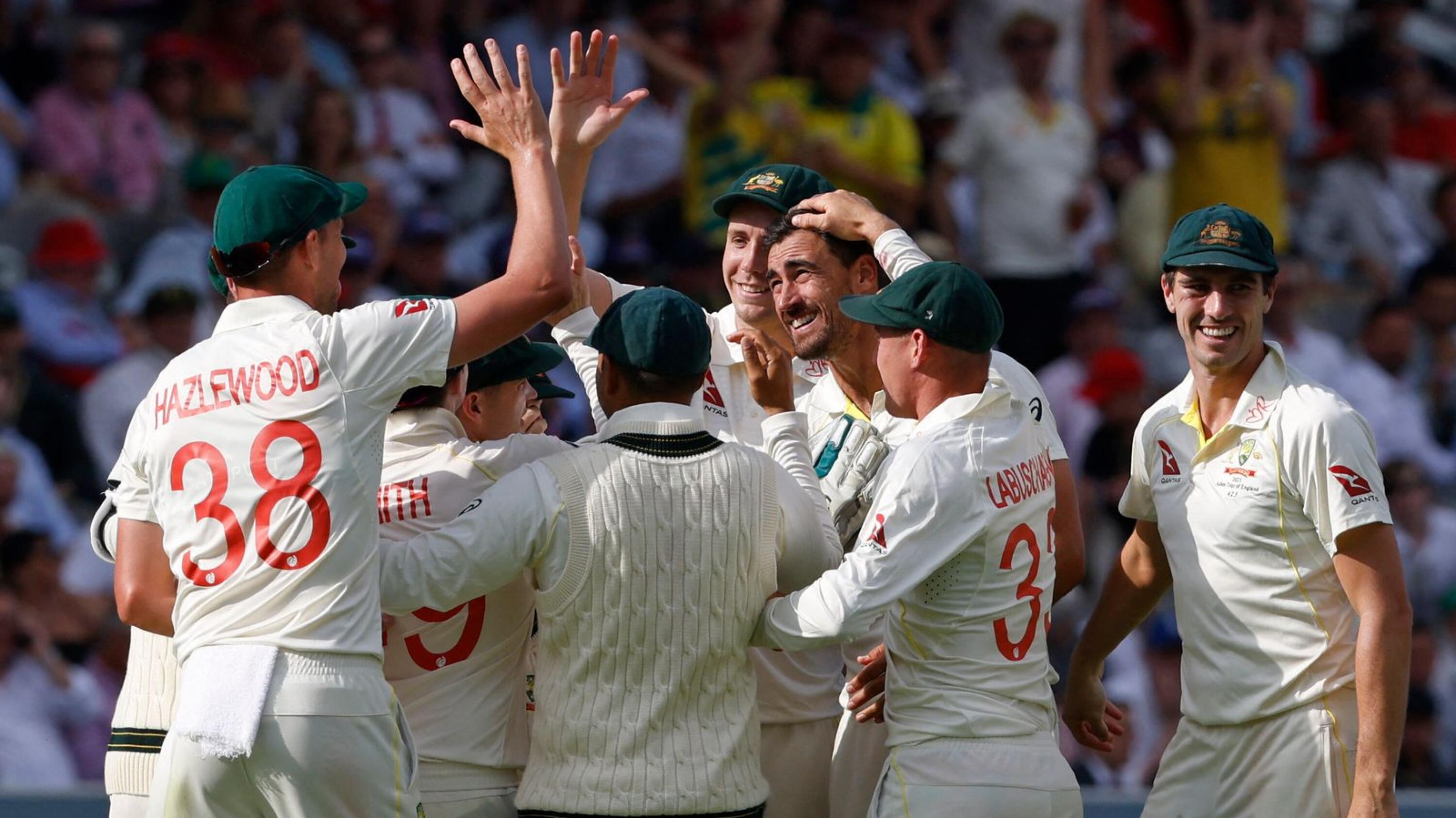 Australia's Mitchell Starc celebrates with teammates after taking the wicket of England's Joe Root on day two of the second Ashes cricket Test match at Lord's cricket ground in London on Thursday