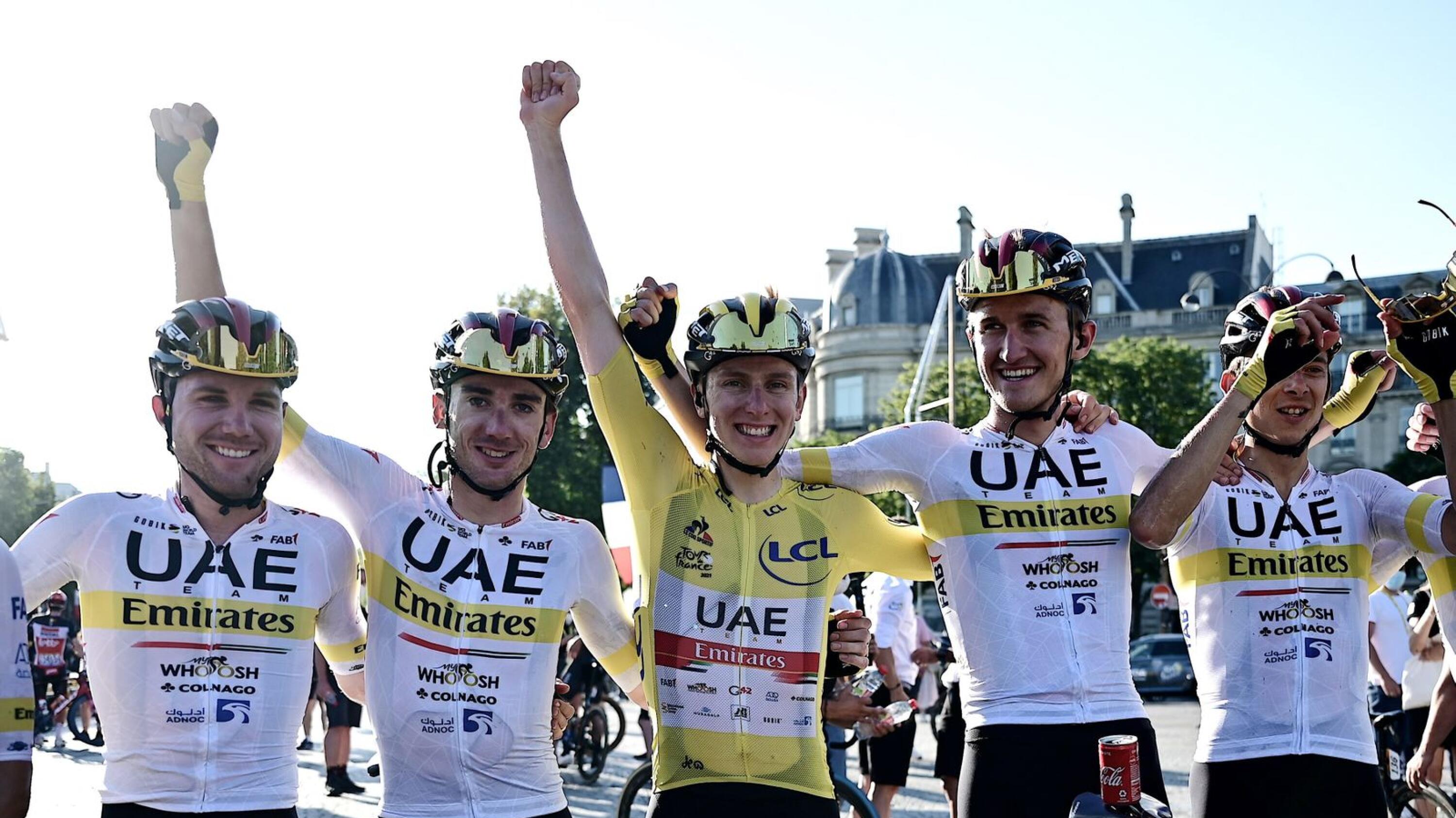 UAE Team Emirates rider Tadej Pogacar of Slovenia wearing the yellow jersey celebrates with his teammates after winning the Tour de France