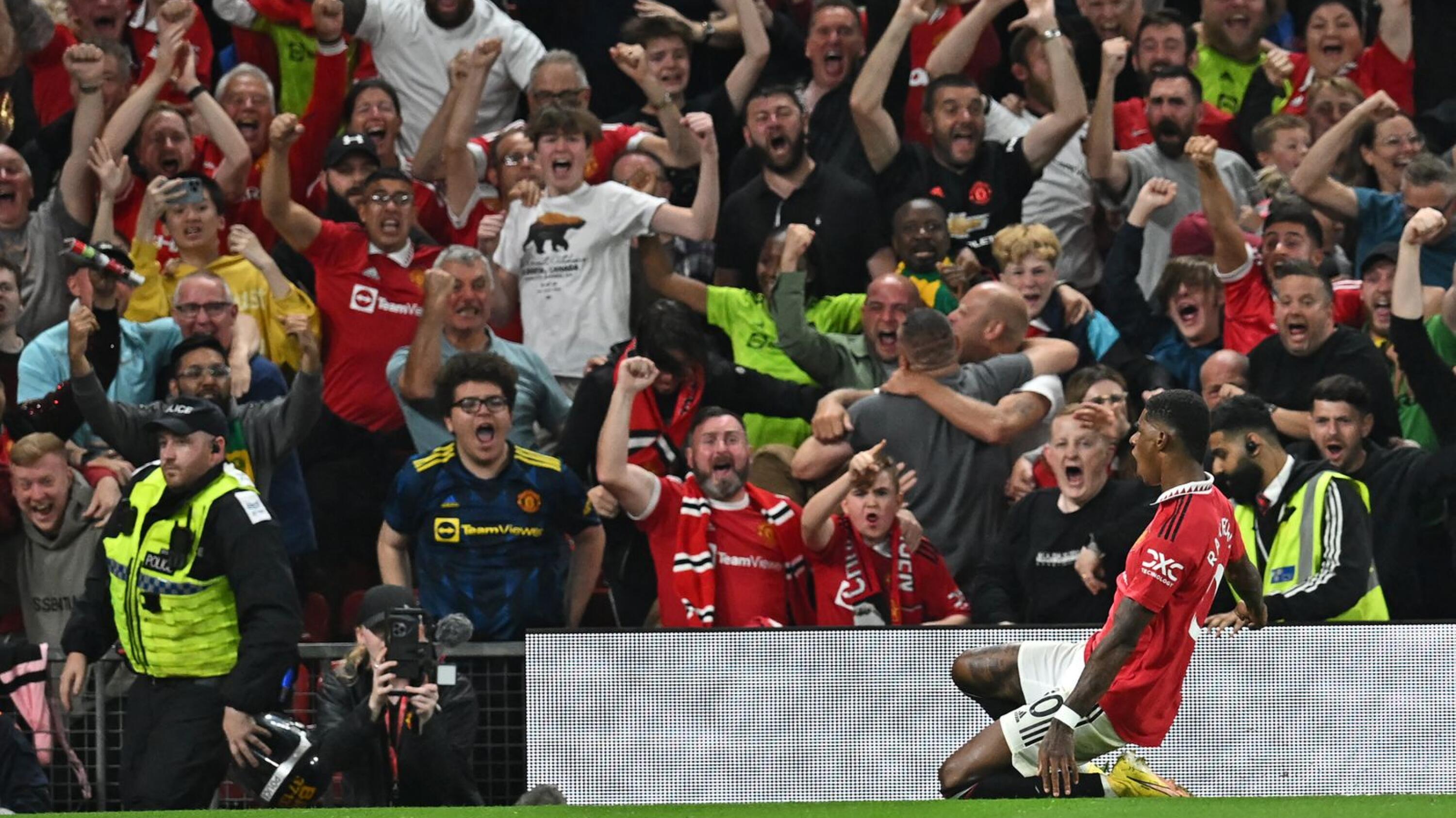 Manchester United's Marcus Rashford celebrates in front of supporters after scoring their second goal during their Premier League match against Liverpool at Old Trafford in Manchester on Monday