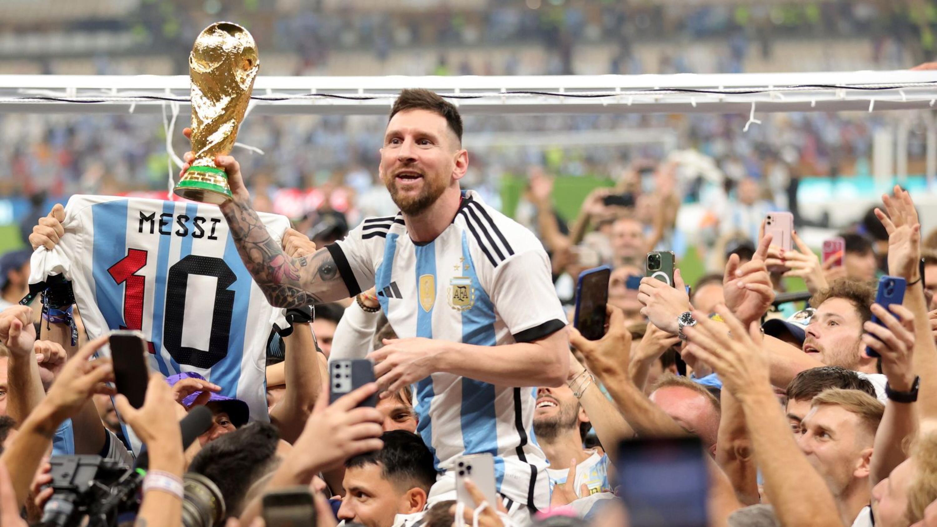 Lionel Messi (centre) of Argentina lifts the World Cup trophy after winning the FIFA World Cup 2022 final