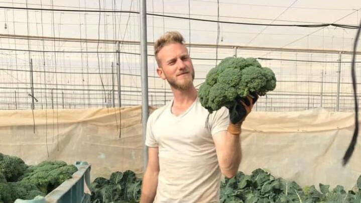 A man holding vegetables 