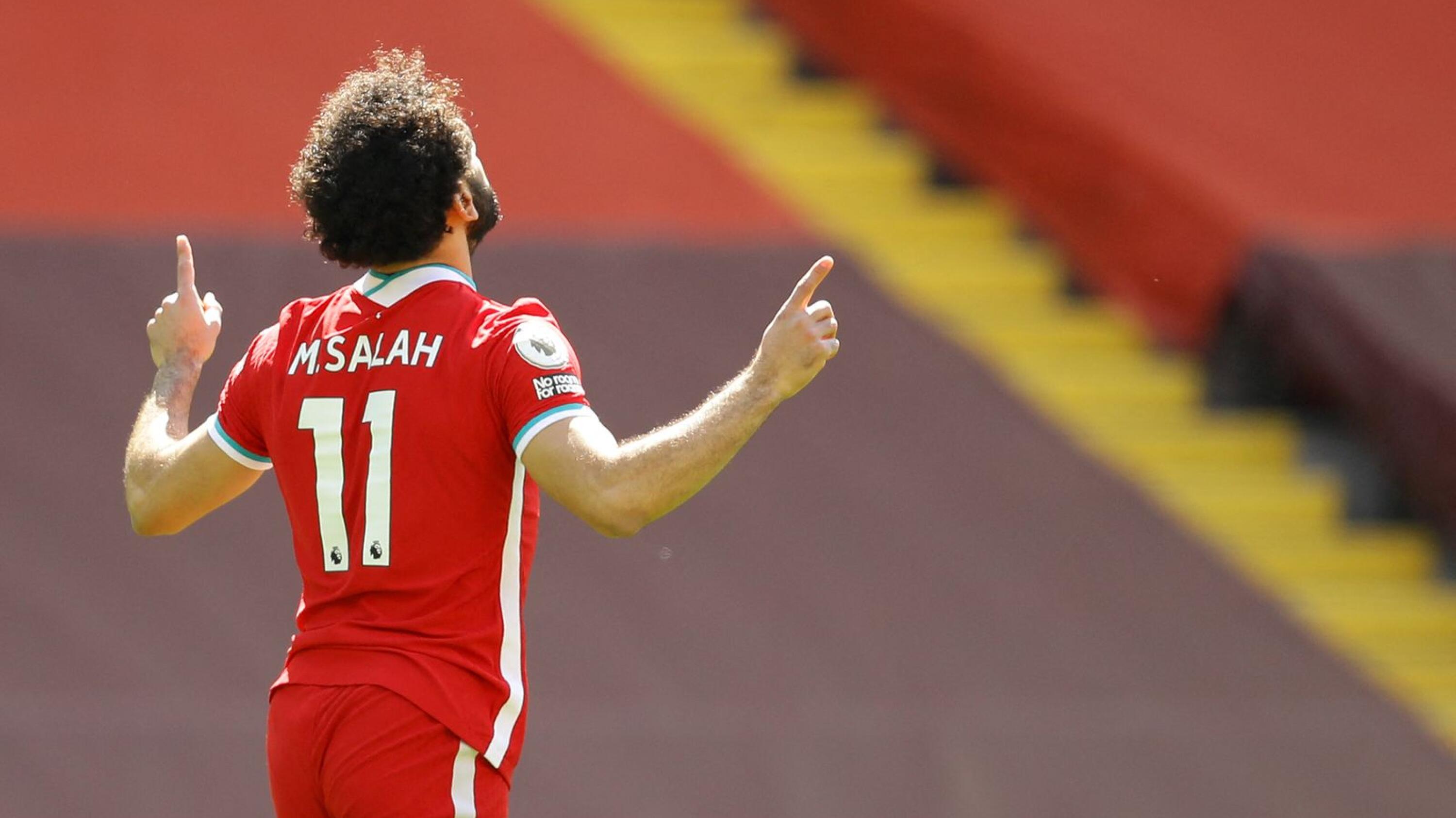 Liverpool's Egyptian midfielder Mohamed Salah celebrates scoring the opening goal during the English Premier League football match between Liverpool and Newcastle United at Anfield in Liverpool, north west England