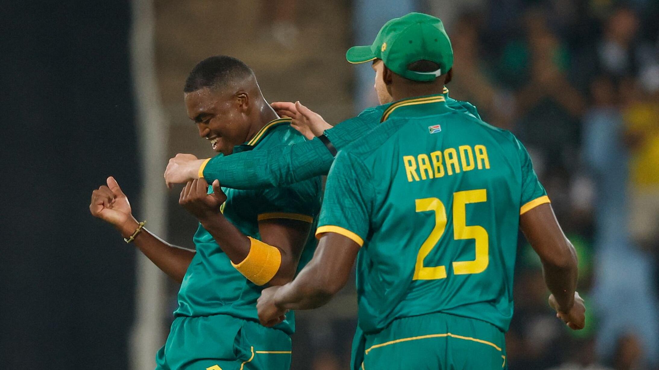 Proteas bowler Lungi Ngidi is hugged by his team mates after taking a wicket against Australia 