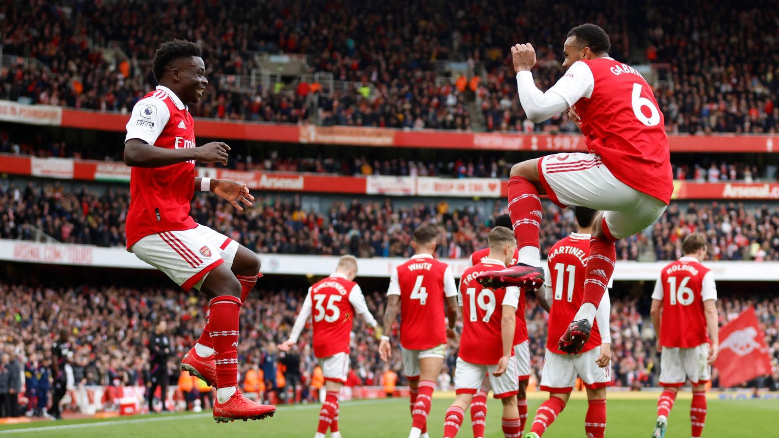 Arsenal's Bukayo Saka celebrates with his teammates after scoring their second goal during their Premier League clash against Crystal Palace at the Emirates Stadium in London on Sunday