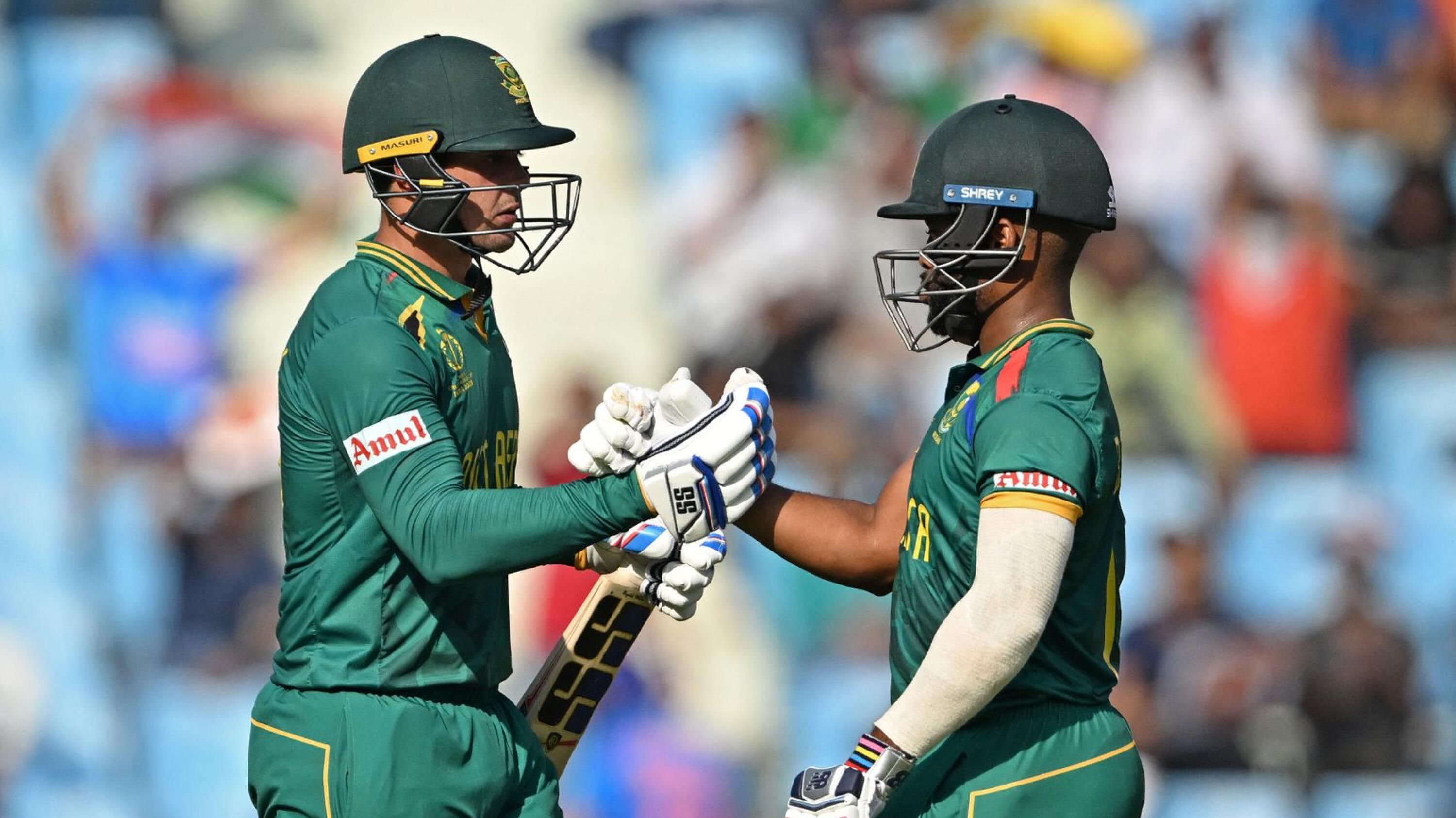 South Africa's Quinton de Kock celebrates with Temba Bavuma after scoring a half-century during their Cricket World Cup match against Australia
