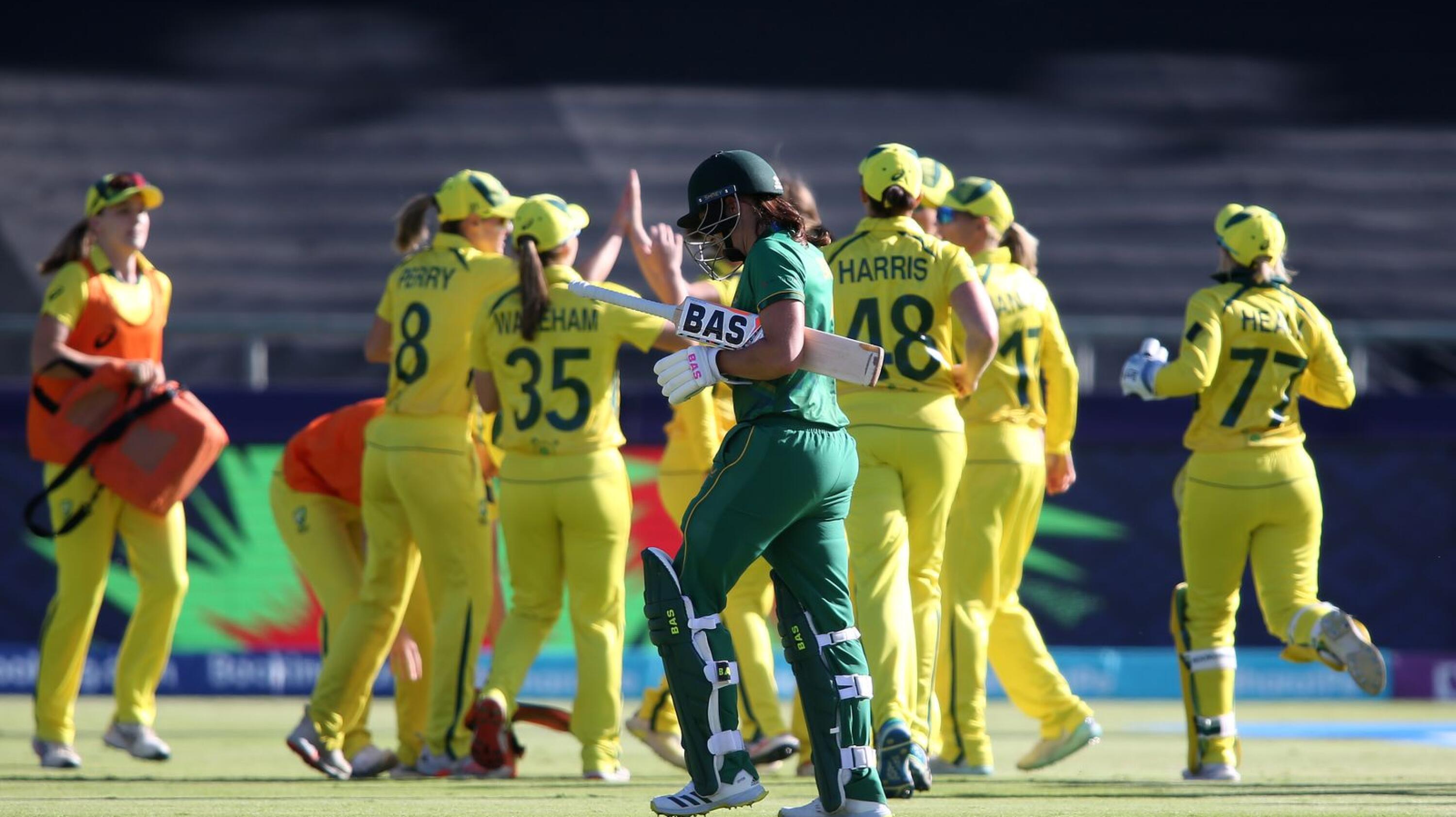 Tazmin Brits of South Africa leaves the field after losing her wicket as Australia celebrate during the 2023 ICC Women's T20 World Cup Final at Newlands Cricket Ground in Cape Town on Sunday