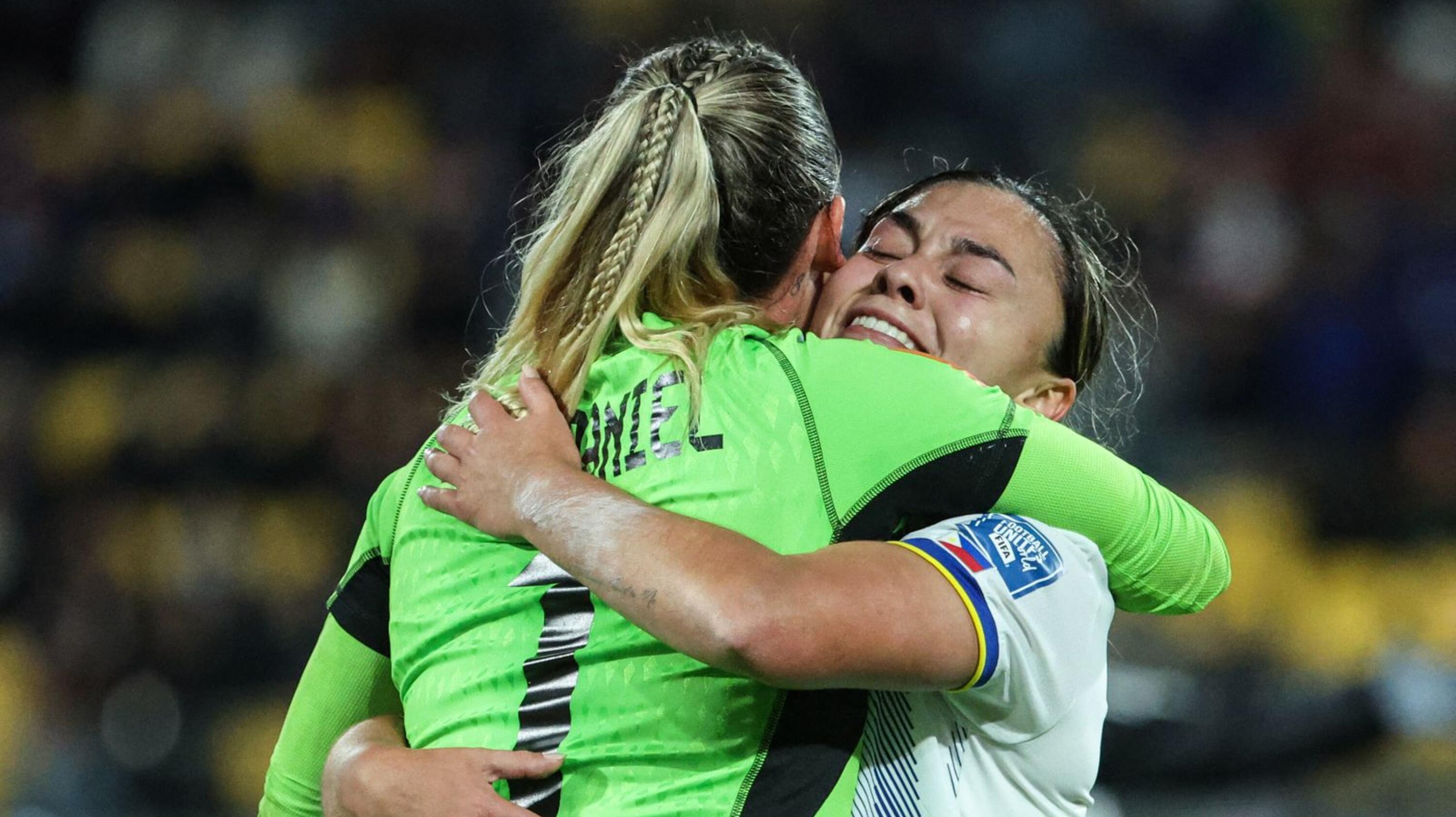Philippines' goalkeeper Olivia McDaniel (L) celebrates with Philippines' defender Sofia Harrison (R) after winning against New Zealand in their Fifa Women's World Cup Group A football match at Wellington Stadium