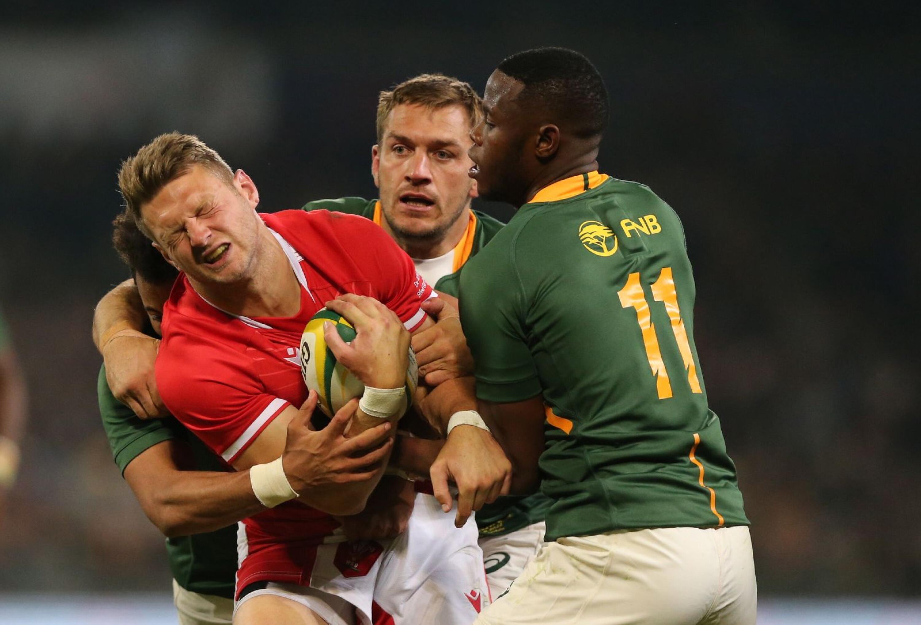 Wales captain Dan Biggar (left) is tackled by Aphelele Fassi of South Africa (right) during the Test match at the Toyota Stadium in Bloemfontein