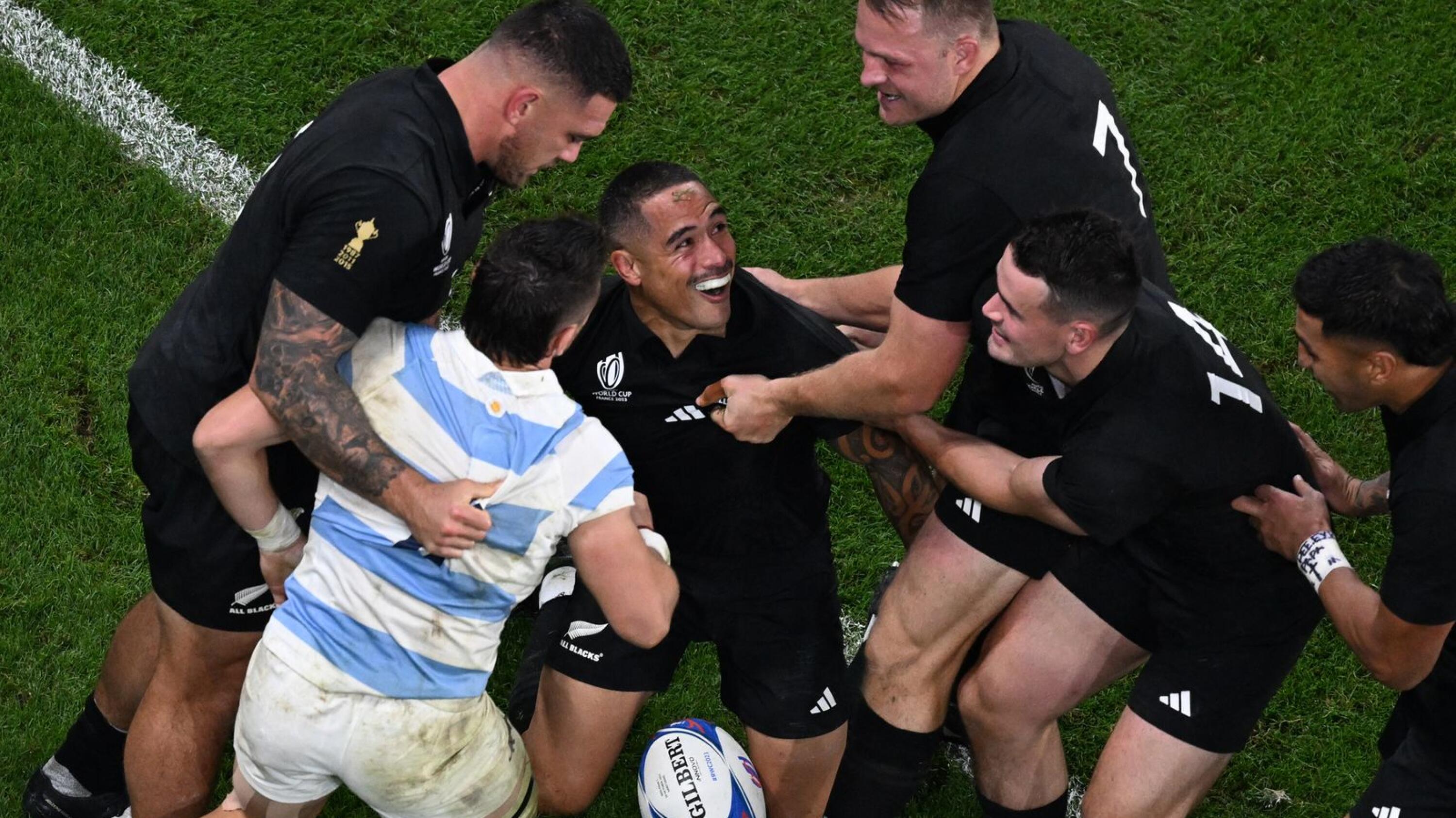 New Zealand scrumhalf Aaron Smith celebrates with teammates after scoring a try during their Rugby World Cup semi-final against Argentina at the Stade de France in Saint-Denis on Friday