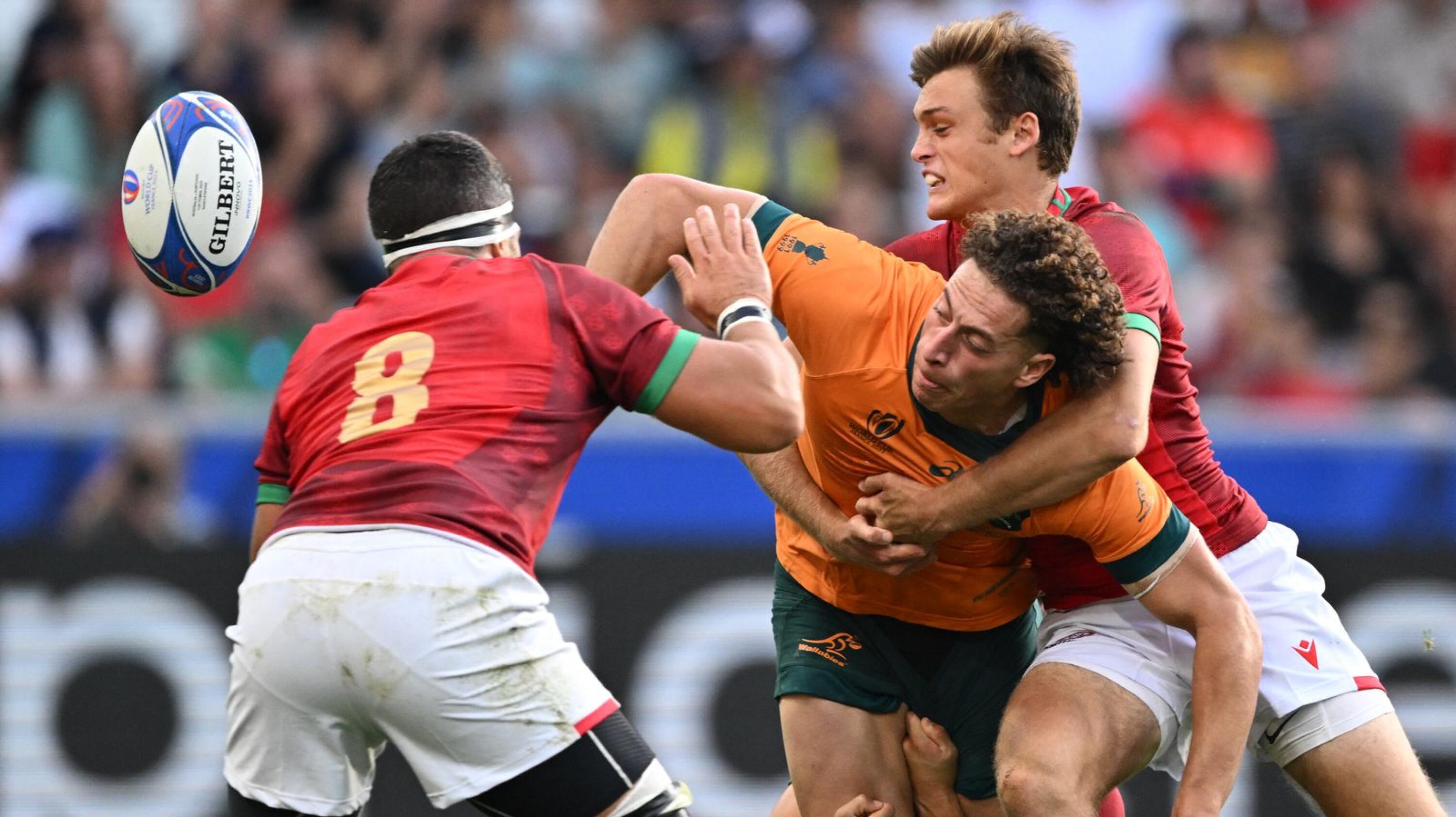 Australia's Mark Nawaqanitawase is tackled by Portugal's Jeronimo Portela and Thibault de Freitas during their Rugby World Cup Pool C match