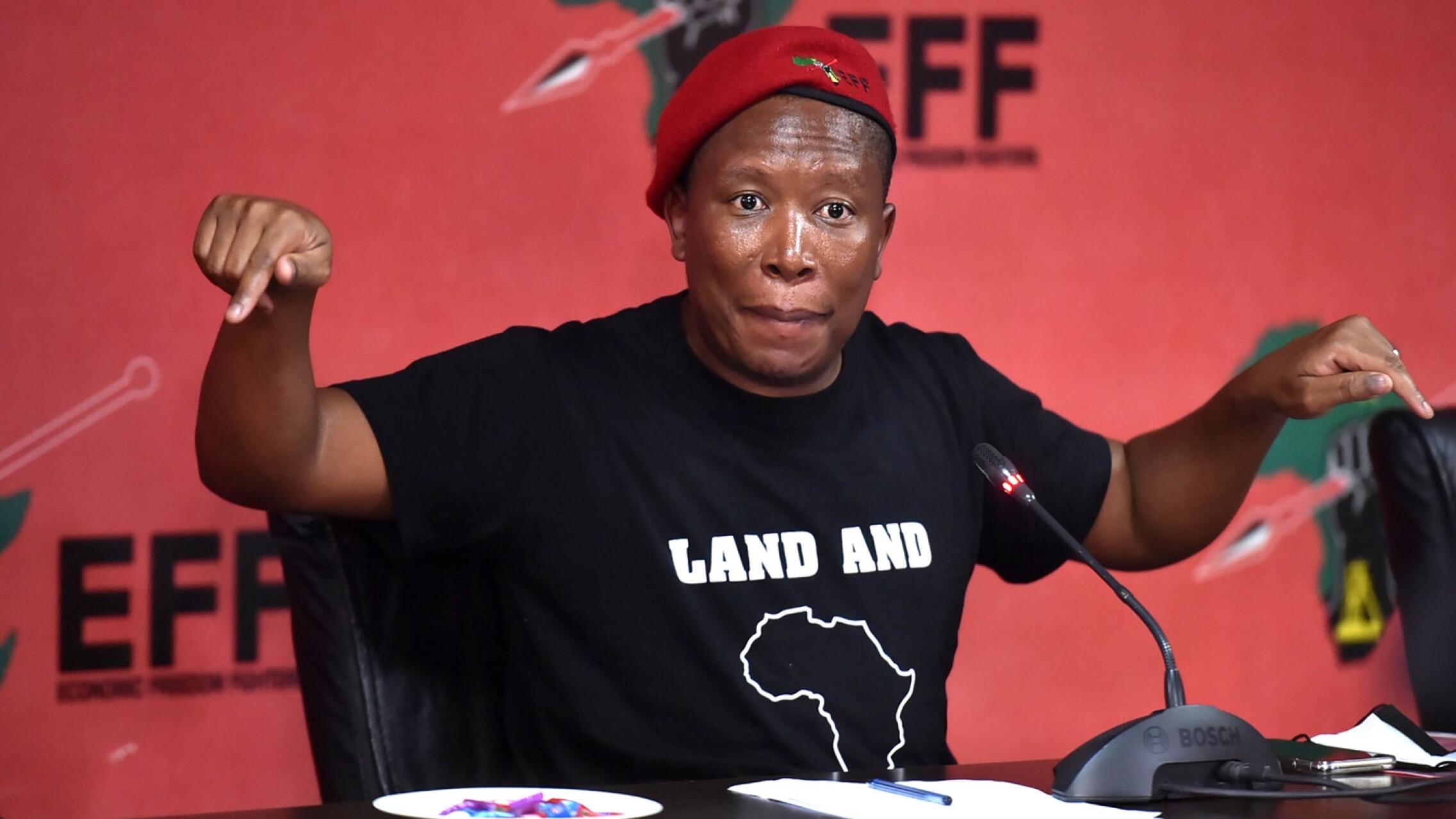 A man in black t-shirt and EFF banner behind him 