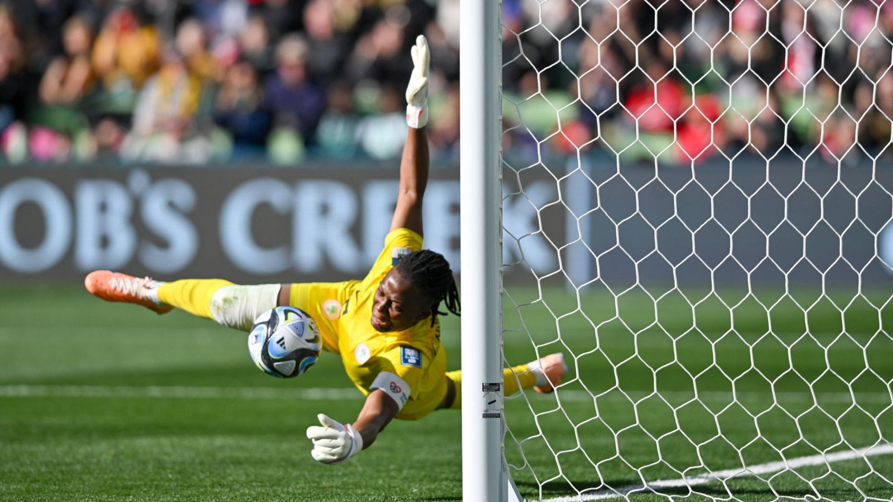 Nigeria's goalkeeper Chiamaka Nnadozie saves a penalty kick by Canada's forward Christine Sinclair during the Fifa Women's World Cup Group B football match at Melbourne Rectangular Stadium, also known as AAMI Park, in Melbourne