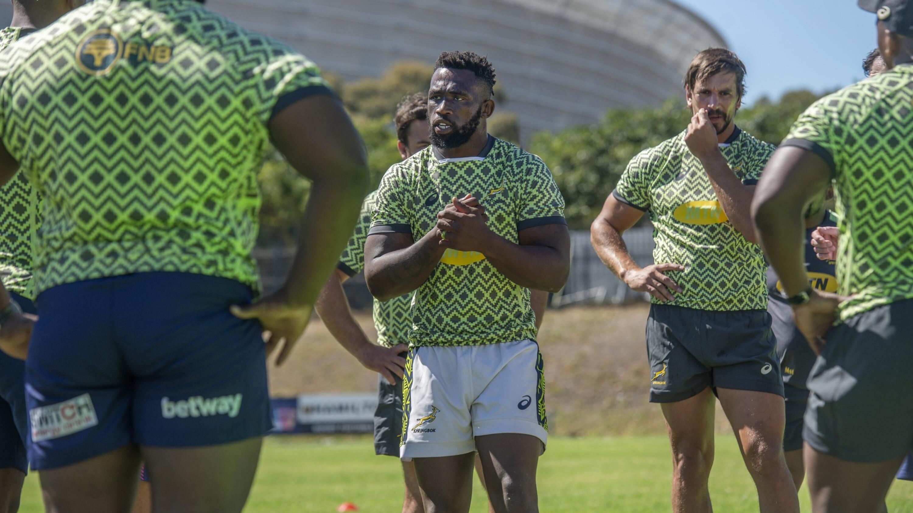 Springbok captain Siya Kolisi (centre) talks to his team during a training session, while Eben Etzebeth (right) looks on with the rest of the players.