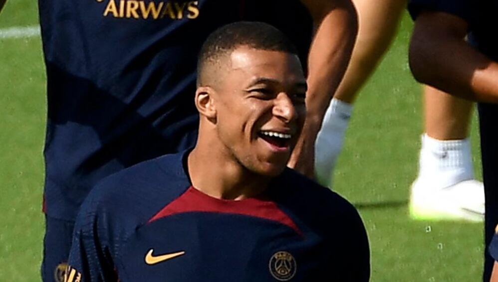 Paris Saint-Germain's French forward Kylian Mbappe (L) and his younger brother Paris Saint-Germain's French Midfielder Ethan Mbappe react as they take part in a training session at the new campus of French L1 Paris Saint-Germain (PSG) football club at Poissy