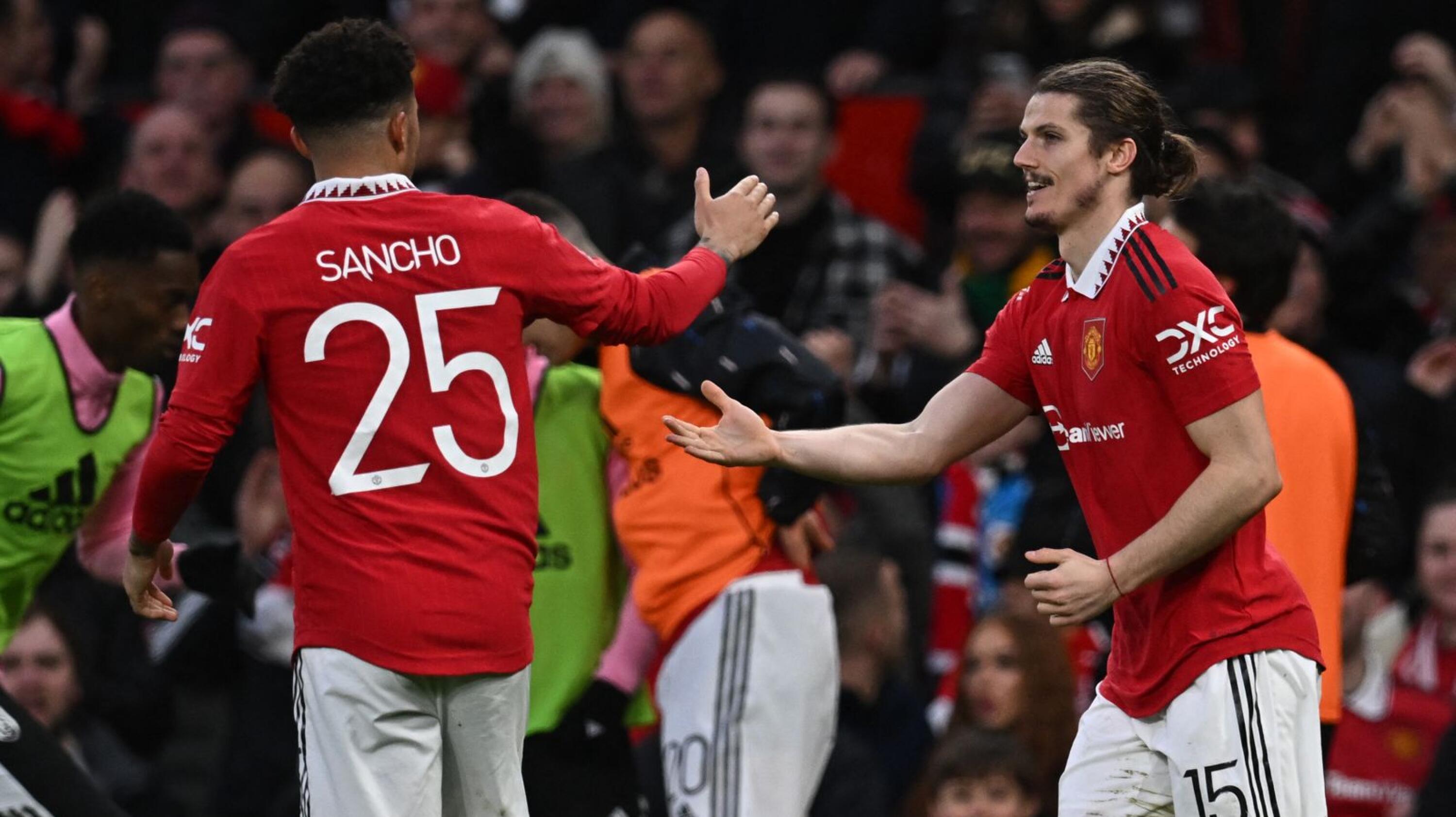Manchester United's Marcel Sabitzer celebrates with Jadon Sancho after scoring their second goal during their FA Cup quarter-final against Fulham at Old Trafford in Manchester on Sunday
