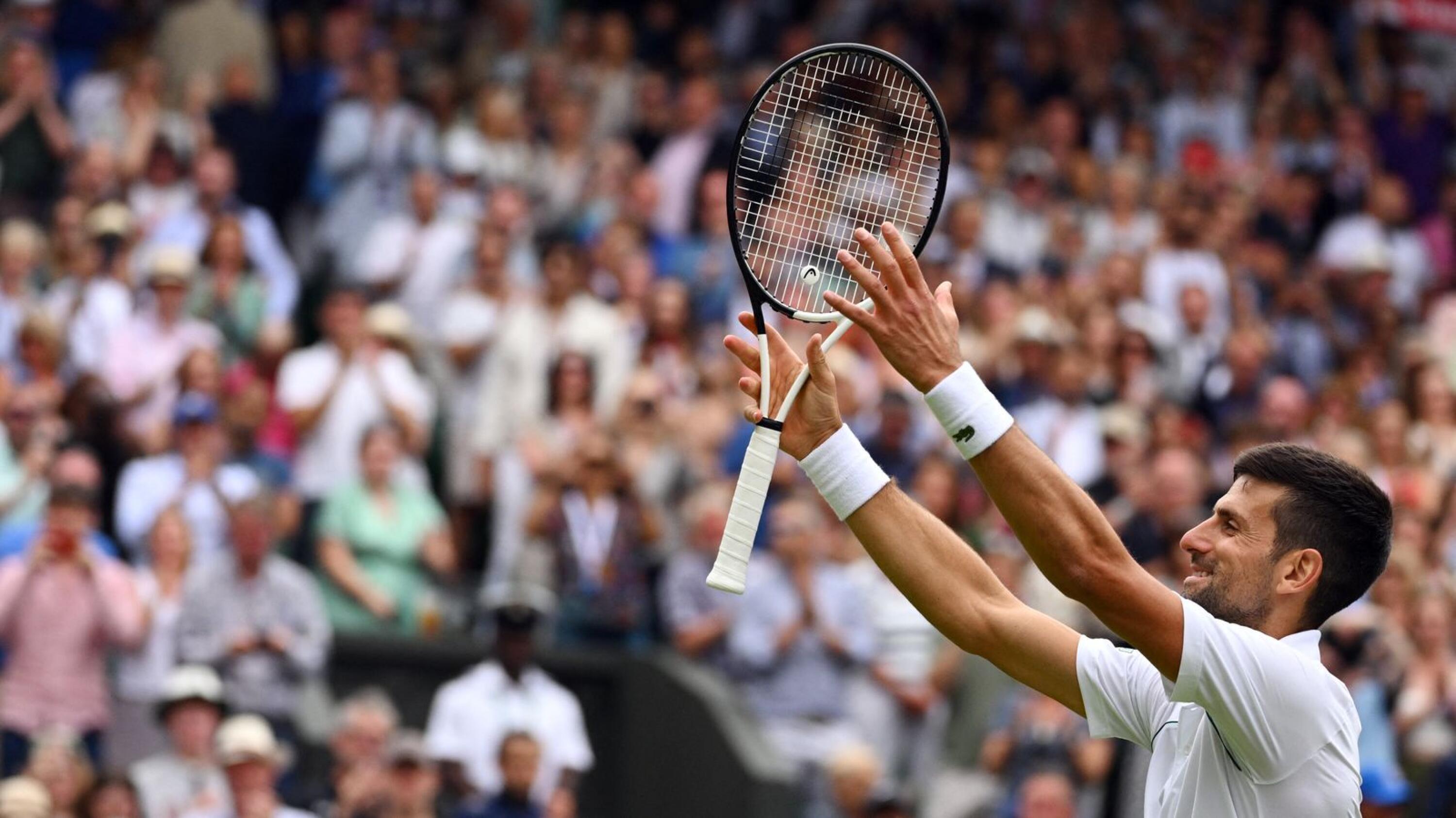 Serbia's Novak Djokovic celebrates beating Jannik Sinner during their men's singles quarter final tennis match on the ninth day of the 2022 Wimbledon Championships at The All England Tennis Club in Wimbledon, southwest London, on Tuesday
