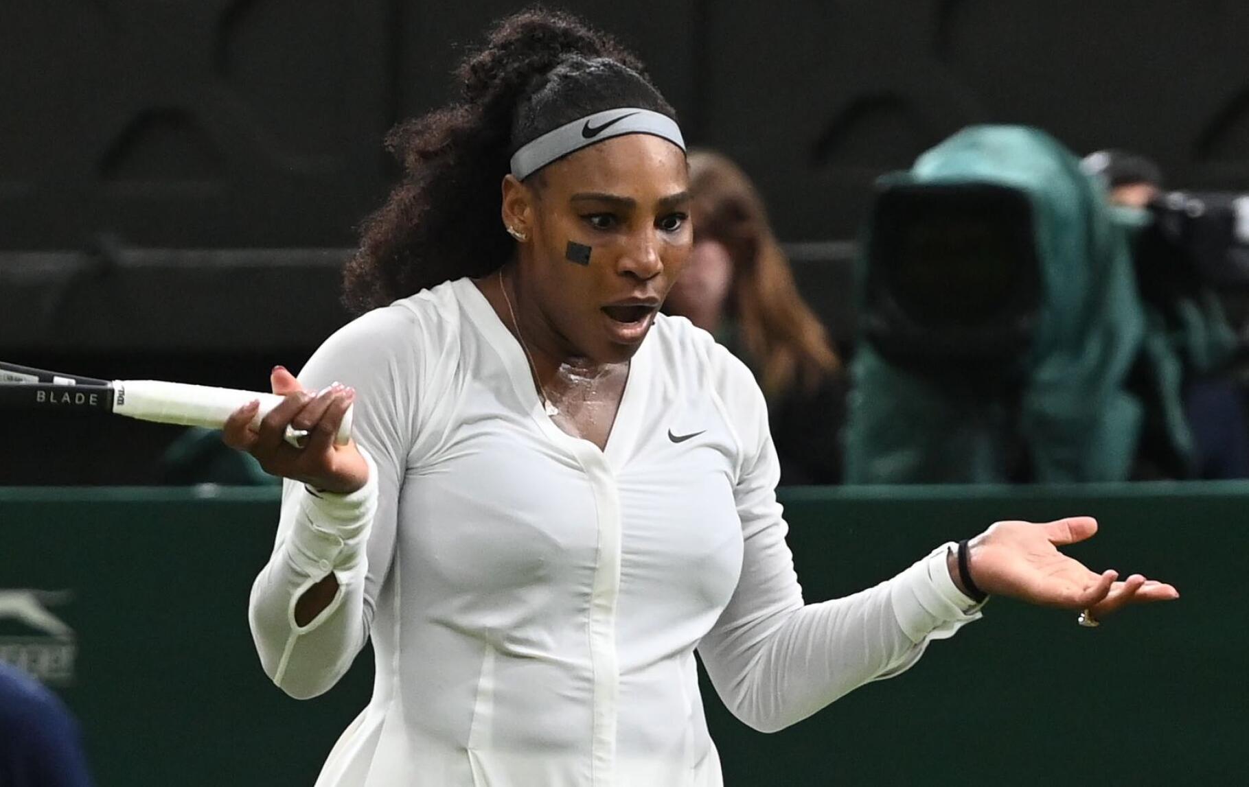 Serena Williams of USA reacts in the women's first round match against Harmony Tan of France at the Wimbledon Championships