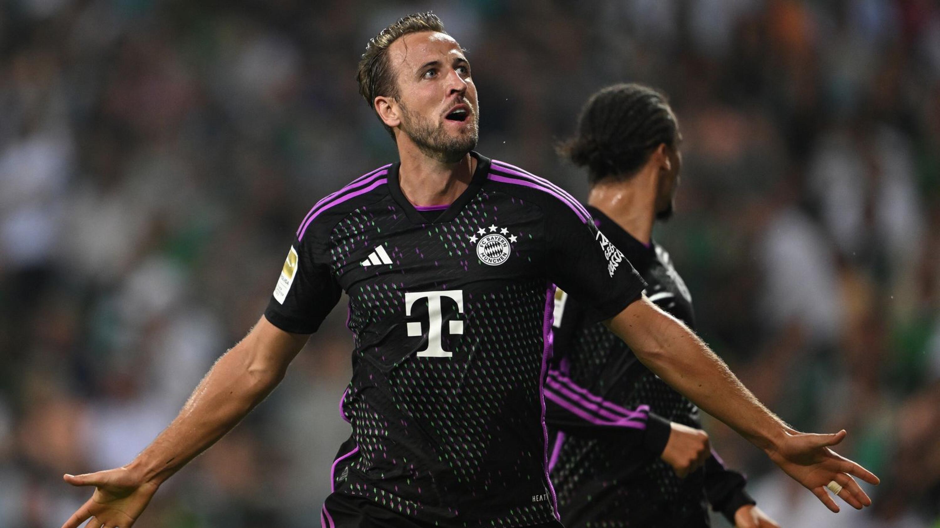 Bayern Munich's English forward Harry Kane celebrates scoring the second goal with his teammates during the German first division Bundesliga football match between Werder Bremen and FC Bayern Munich in Bremen, northern Germany