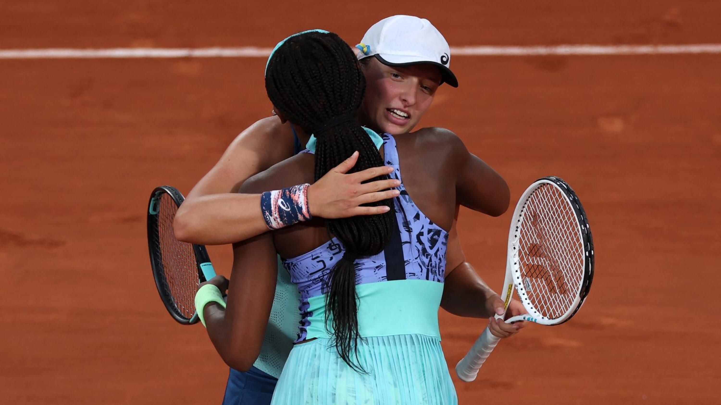 Poland's Iga Swiatek hugs US' Coco Gauff after winning their women's single final match on day fourteen of the Roland-Garros Open tennis tournament at the Court Philippe-Chatrier in Paris on Saturday. Swiatek cruised to her second French Open title by dominating Gauff in the final as the world number one claimed her 35th successive victory