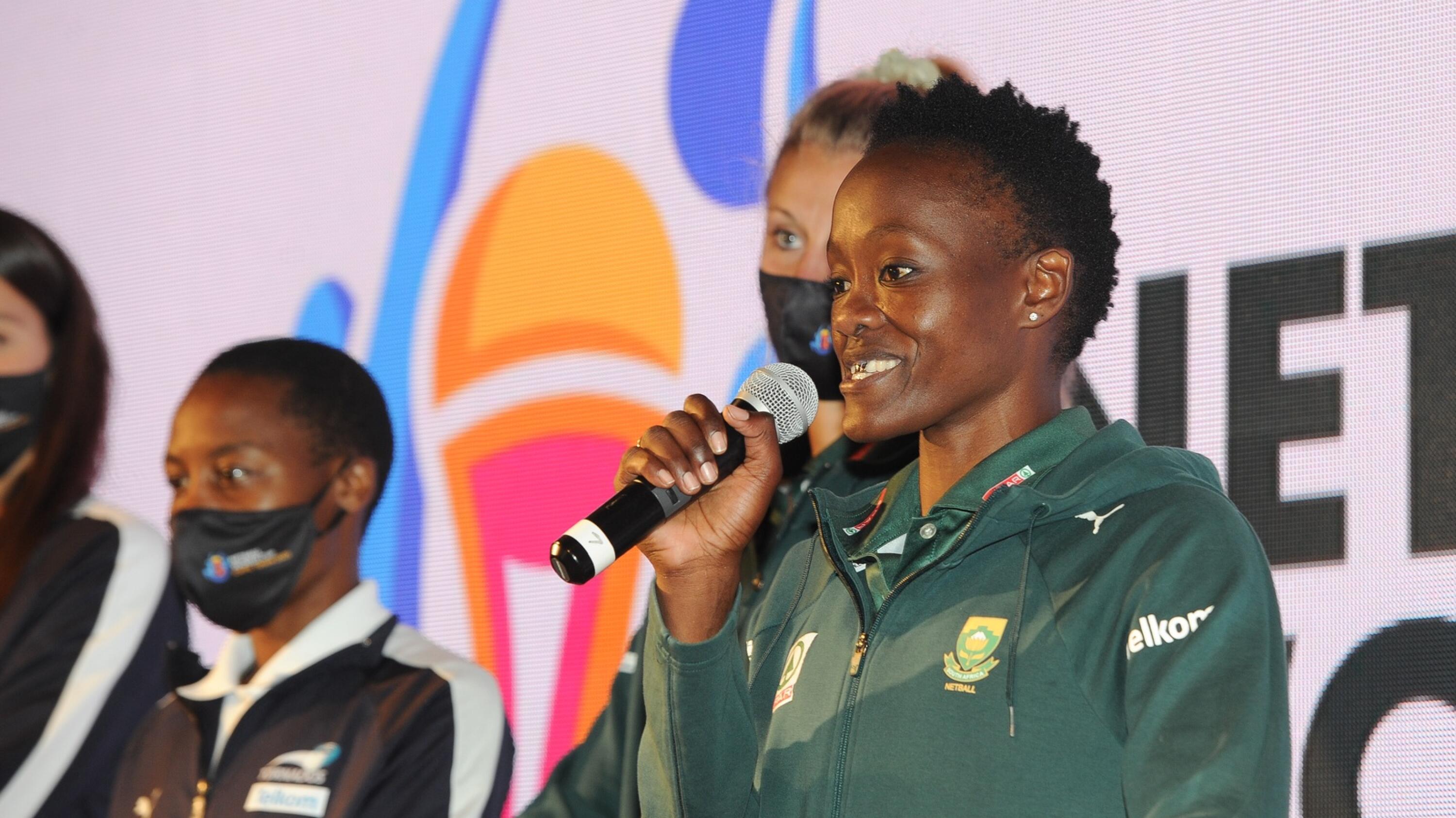 Bongi Msomi hold a mic during a presentation.