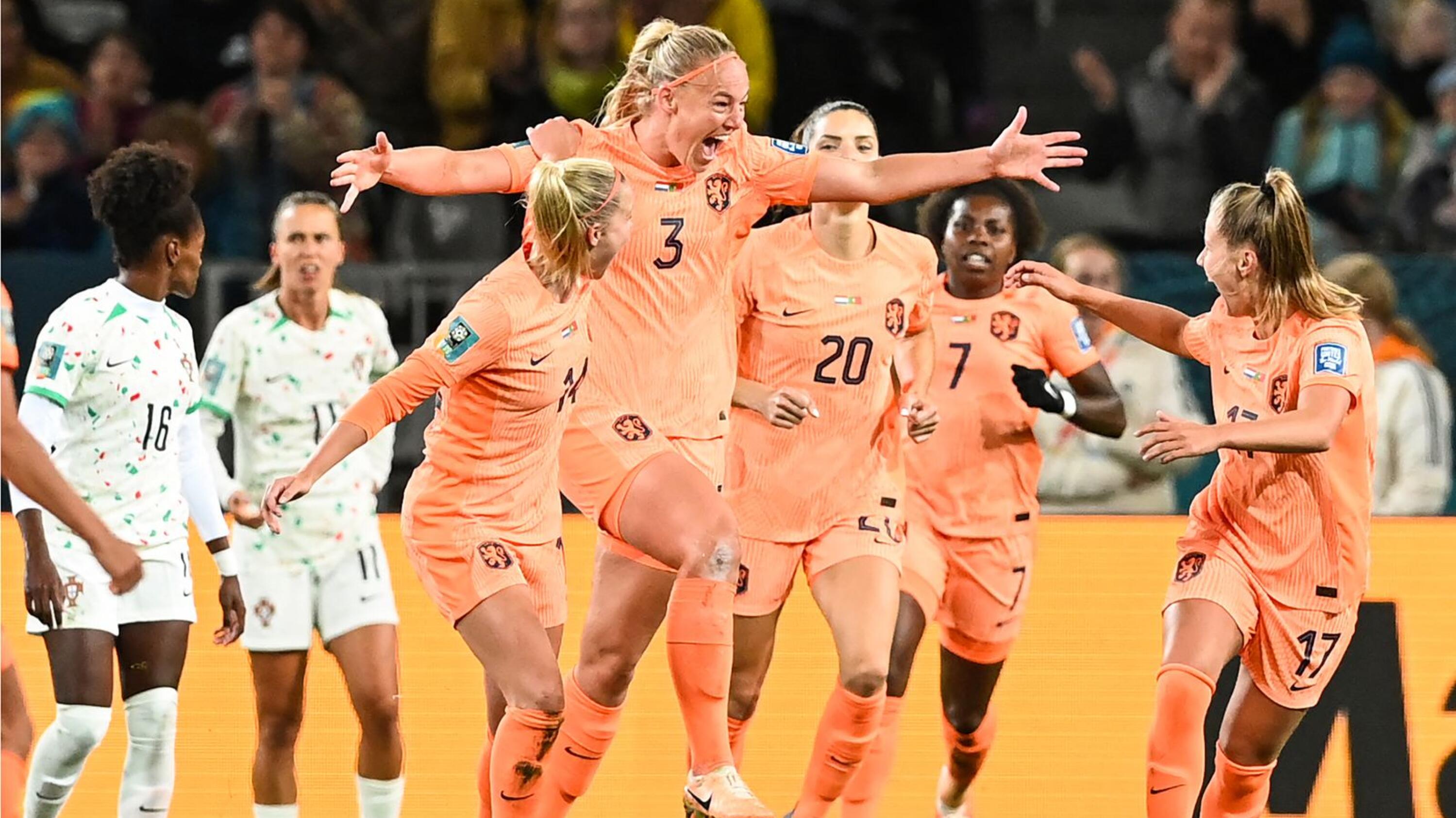 Netherlands' defender Stefanie van der Gragt celebrates with her teammates after scoring her team's first goal