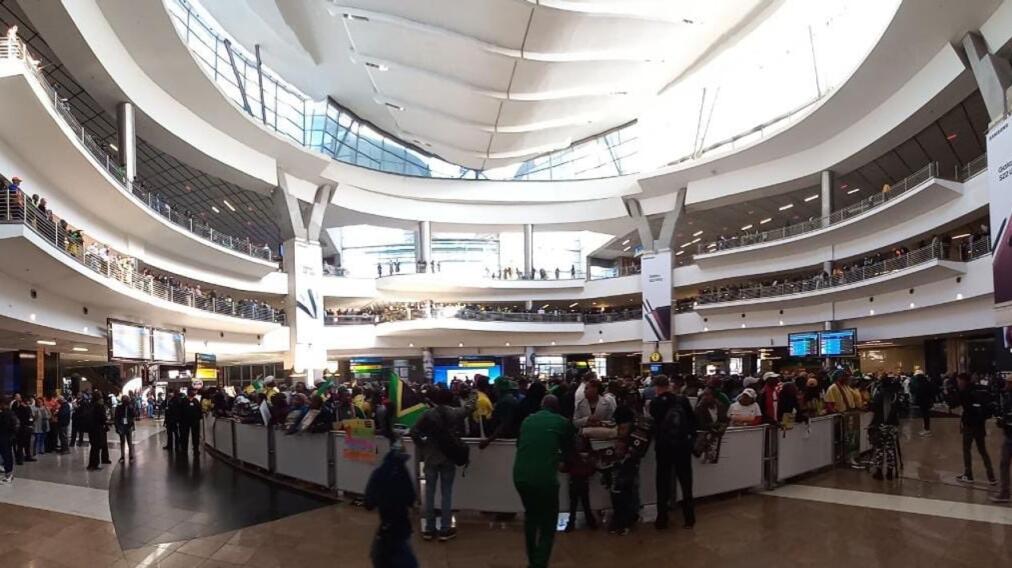 South African fans await the arrival of Banyana Banyana at OR Tambo International in Johannesburg on Tuesday