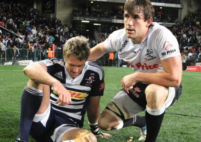 Keegan Daniel comforts Jean de Villiers after the Sharks beat the Stormers in the 2012 Super Rugby semi-final at Newlands.