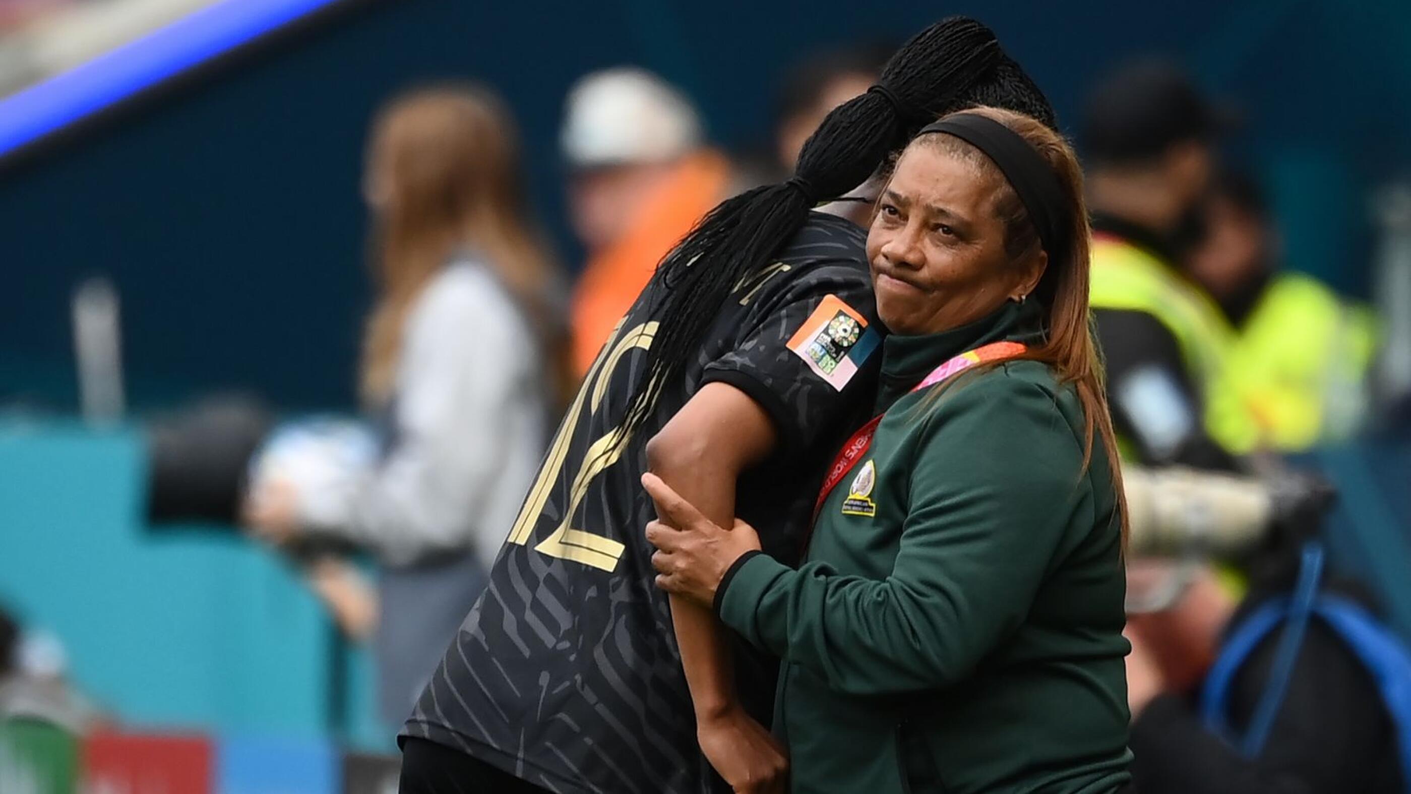 South Africa's coach Desiree Ellis (right) embraces South Africa's Jermaine Seoposenwe as she leaves the pitch for a substitution during the Women's World Cup round of 16 match against Netherlands