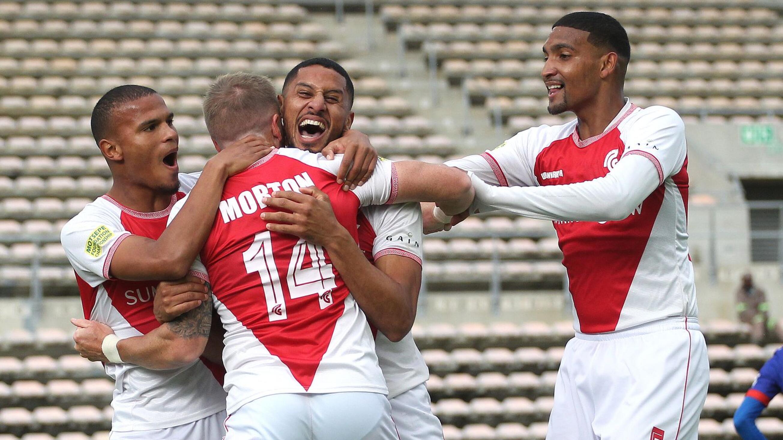 Cape Town Spurs’ Michael Morton celebrates with teammates after scoring the winning goal in their promotion/relegation play-off against Maritzburg United at Athlone Stadium in Cape Town Spurs on Saturday