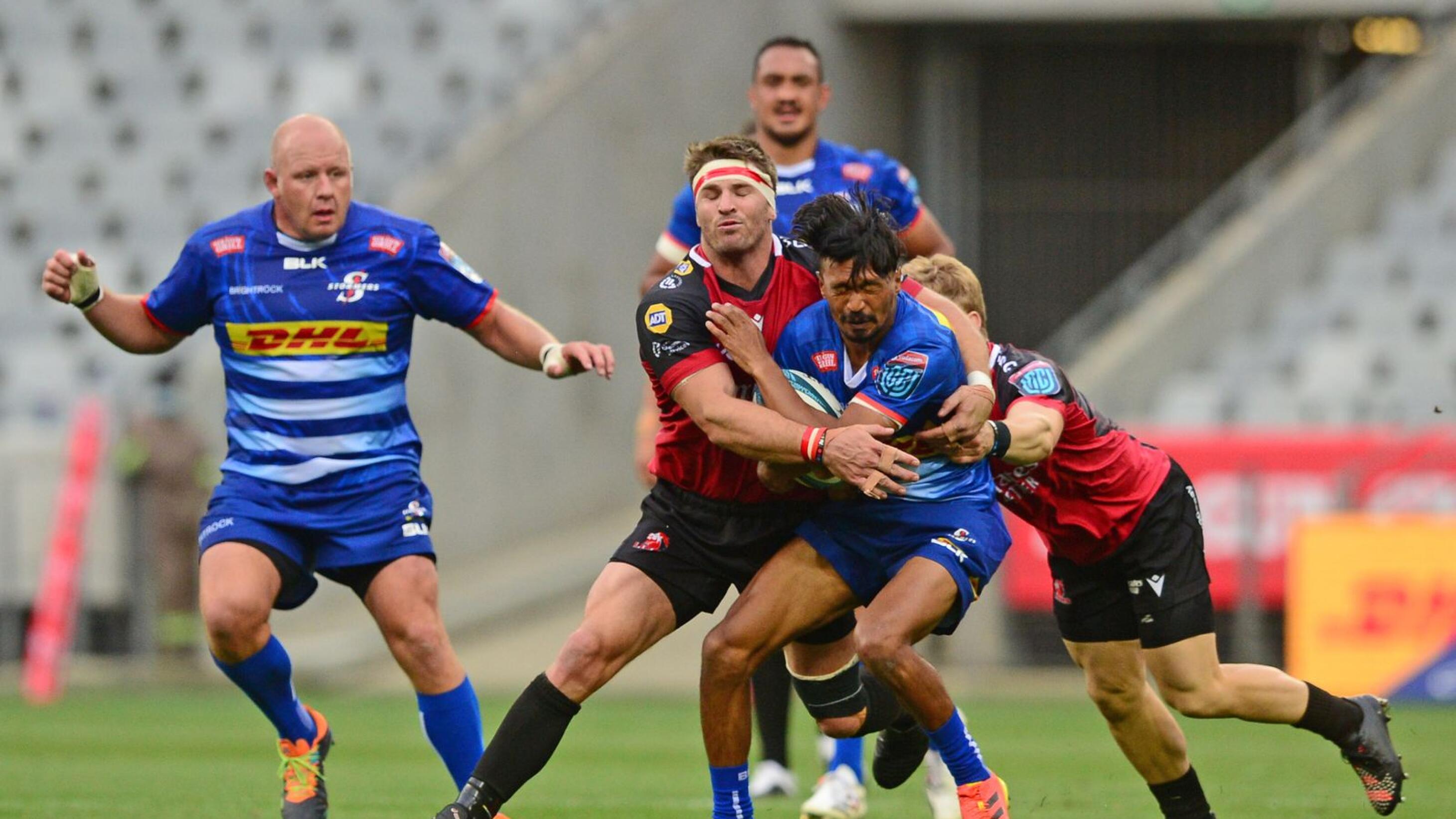 Tristan Leyds of the Stormers is tackled by Jaco Kriel and Morne van der Berg of the Lions during their United Rugby Championship game at Cape Town Stadium in Cape Town on Saturday