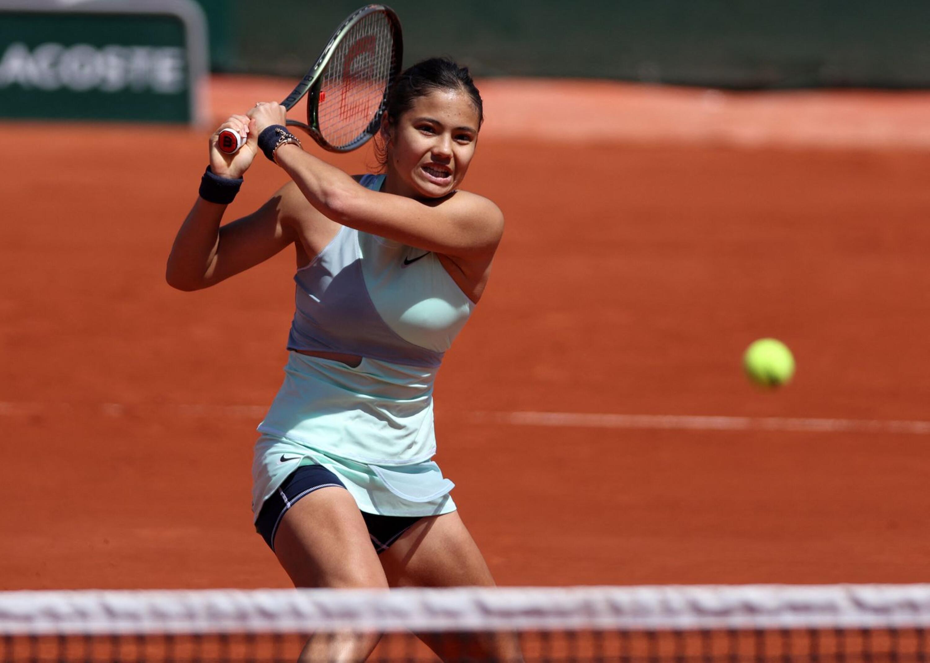 Britain's Emma Raducanu returns the ball to Belarus' Aliaksandra Sasnovich during their women's singles match on day four of the Roland-Garros Open tennis tournament at the Court Suzanne-Lenglen in Paris on Tuesday