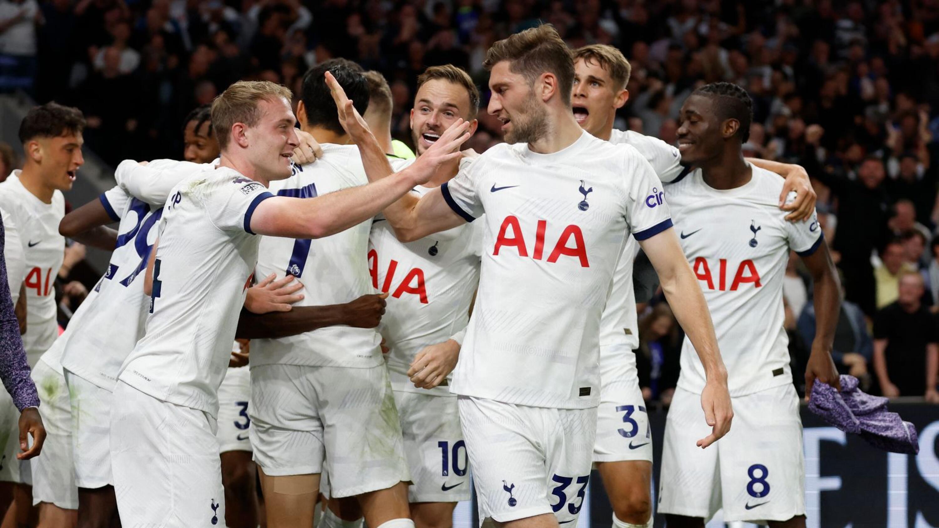 Tottenham Hotspur players celebrate after Liverpool’s Joel Matip scored an injury time own goal during their Premier League