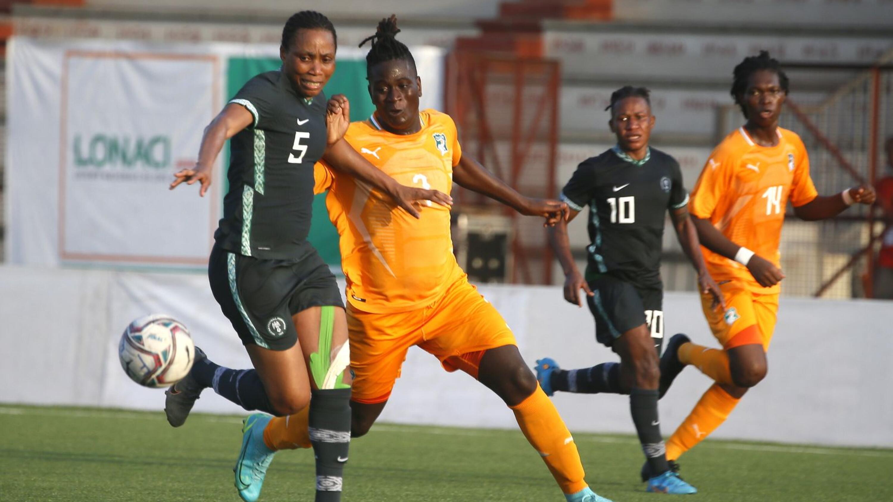 Diakité Binta of Ivory Coast (R)  fights for the ball with Obi Onowe of Nigeria (L) during the Women's Africa Cup of Nations Qualifiers between Ivory Coast and Nigeria at Robert Champroux Stadium in Abidjan