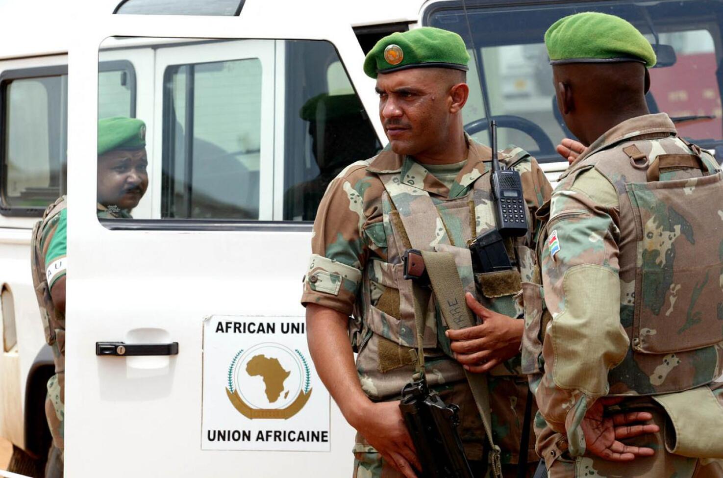 Armed soldiers with a white African Union vehicle