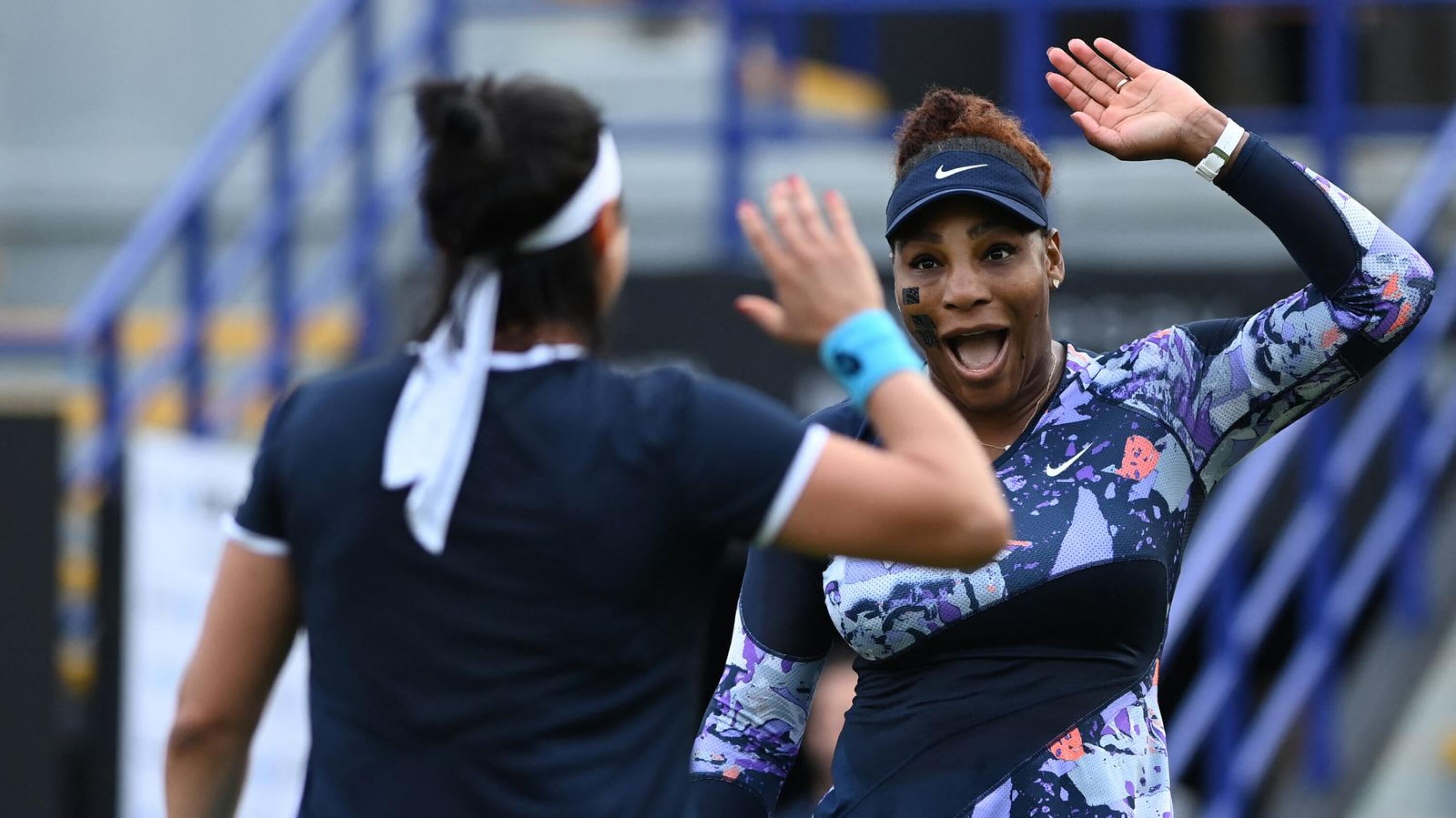 US player Serena Williams and Tunisia's Ons Jabeur celebrate after winning against Spain's Sara Sorribes Tormo and Czech Republic's Marie Bouzkova at the end of their round of 8 women's doubles tennis match, on day three, of the Eastbourne International tennis tournament in Eastbourne, southern England on Tuesday