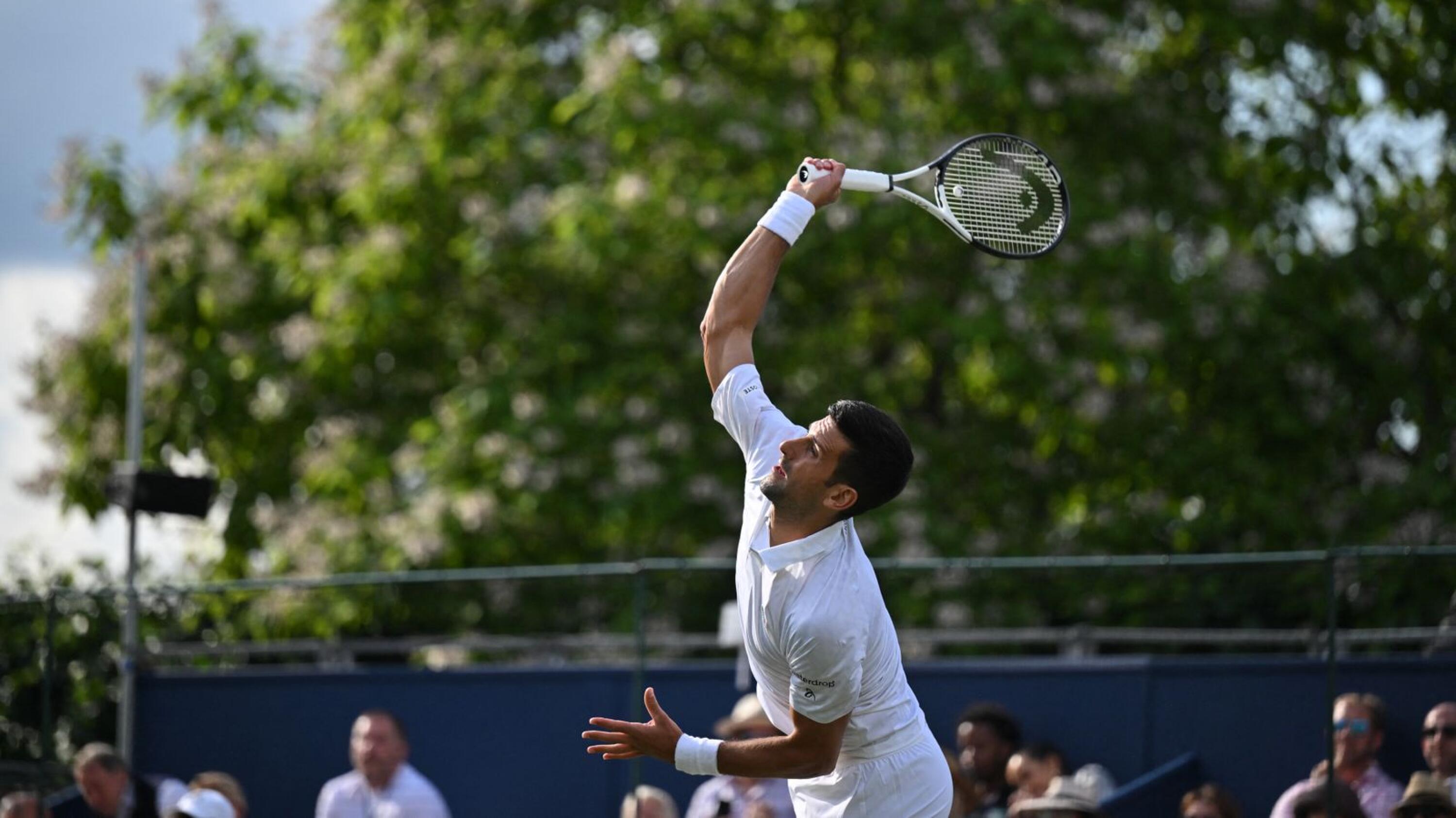 Serbia's Novak Djokovic serves to US player Frances Tiafoe during their men's singles exhibition match at The Giorgio Armani Tennis Classic tournament at the Hurlingham Club in London