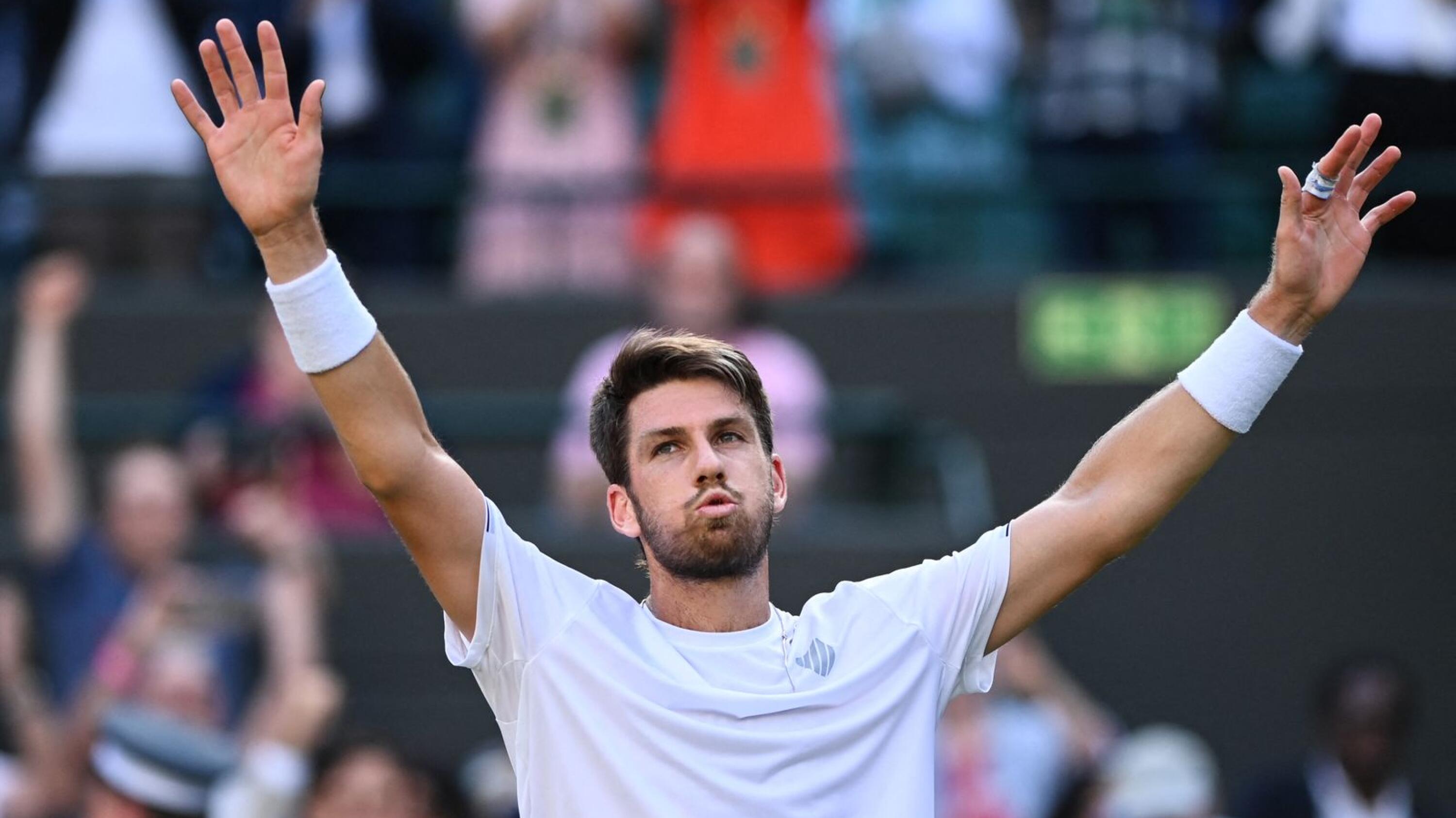 Britain's Cameron Norrie celebrates winning against Belgium's David Goffin at the end of their men's singles quarter final tennis match on the ninth day of the 2022 Wimbledon Championships at The All England Tennis Club in Wimbledon, southwest London, on Tuesday