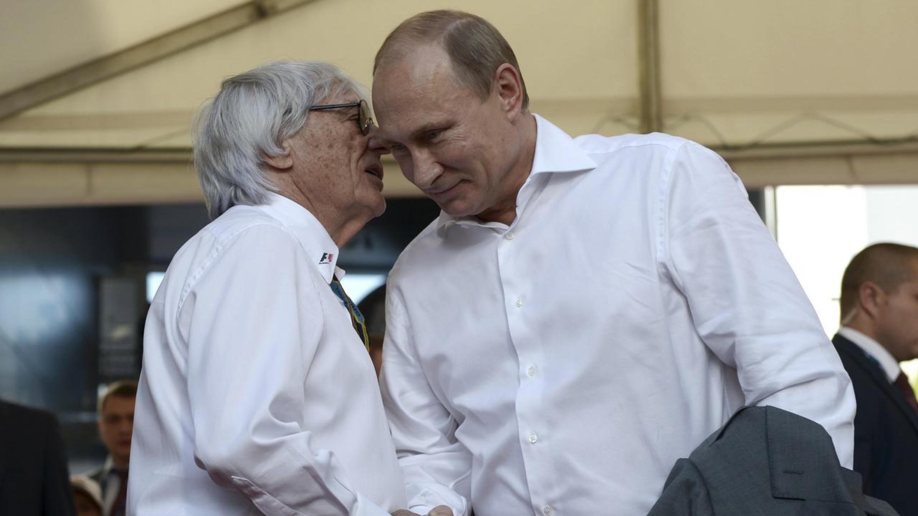 Russia's President Vladimir Putin (R) shakes hands with then Formula One supremo Bernie Ecclestone during the first Russian Grand Prix in Sochi, in this October 12, 2014 file photo