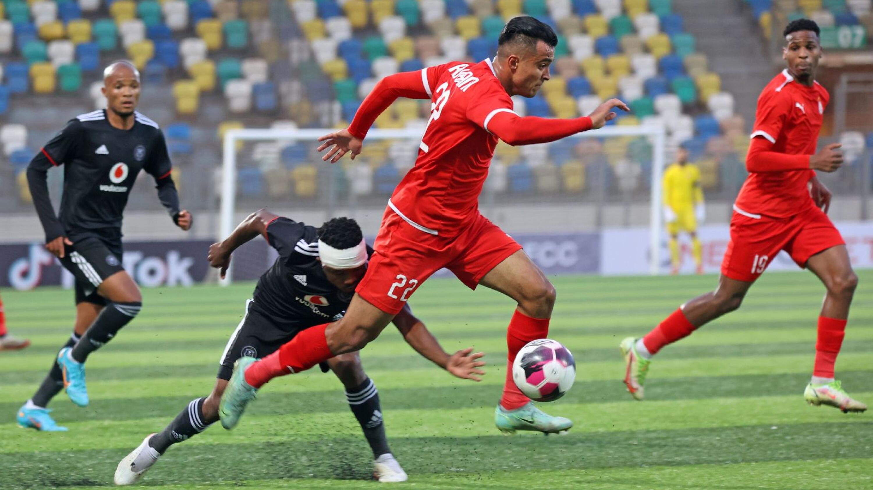 Ahmed Al Haram of Al Ittihad is challenged by Paseka Mako of Orlando Pirates during their CAF Confederation Cup game at Martyrs of February Stadium in Benghazi, Libya on Sunday