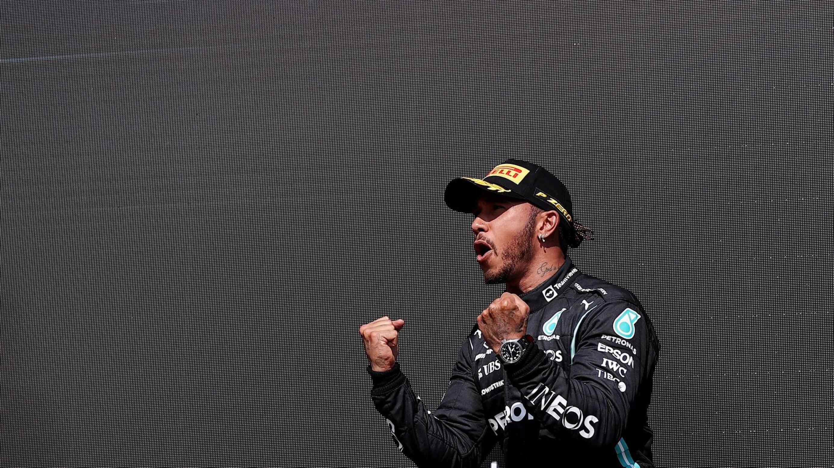 Mercedes' Lewis Hamilton celebrates on the podium after winning the British Grand Prix on Sunday