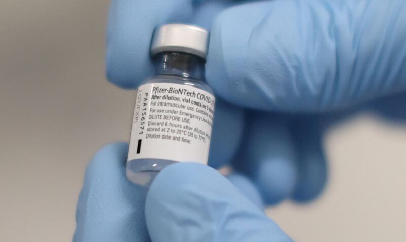 A medical worker holds a vial of the Pfizer/BioNTech Covid-19 vaccine.