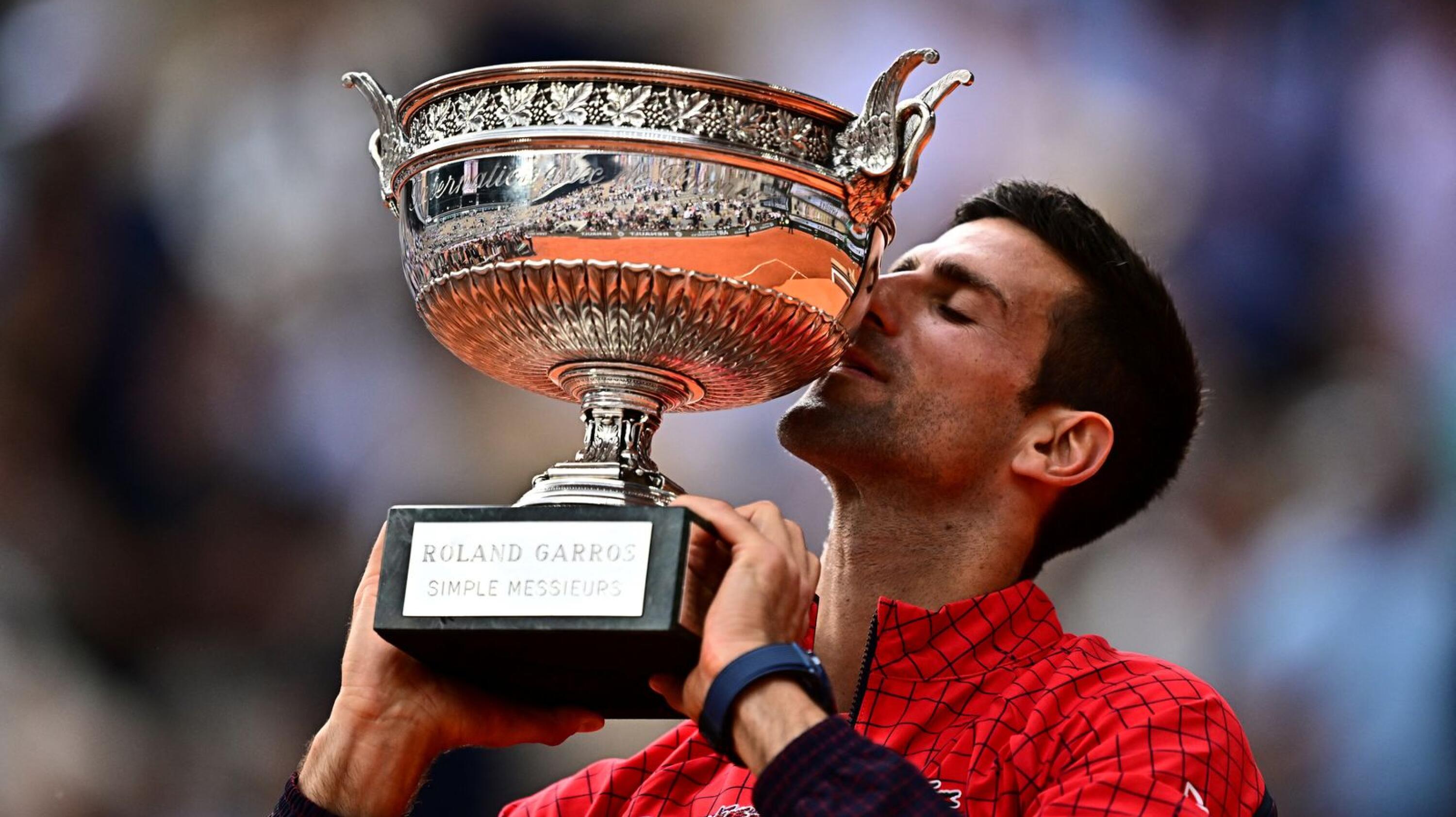 Serbia's Novak Djokovic kisses the trophy after beating Norway's Casper Ruud in the final of the French Open