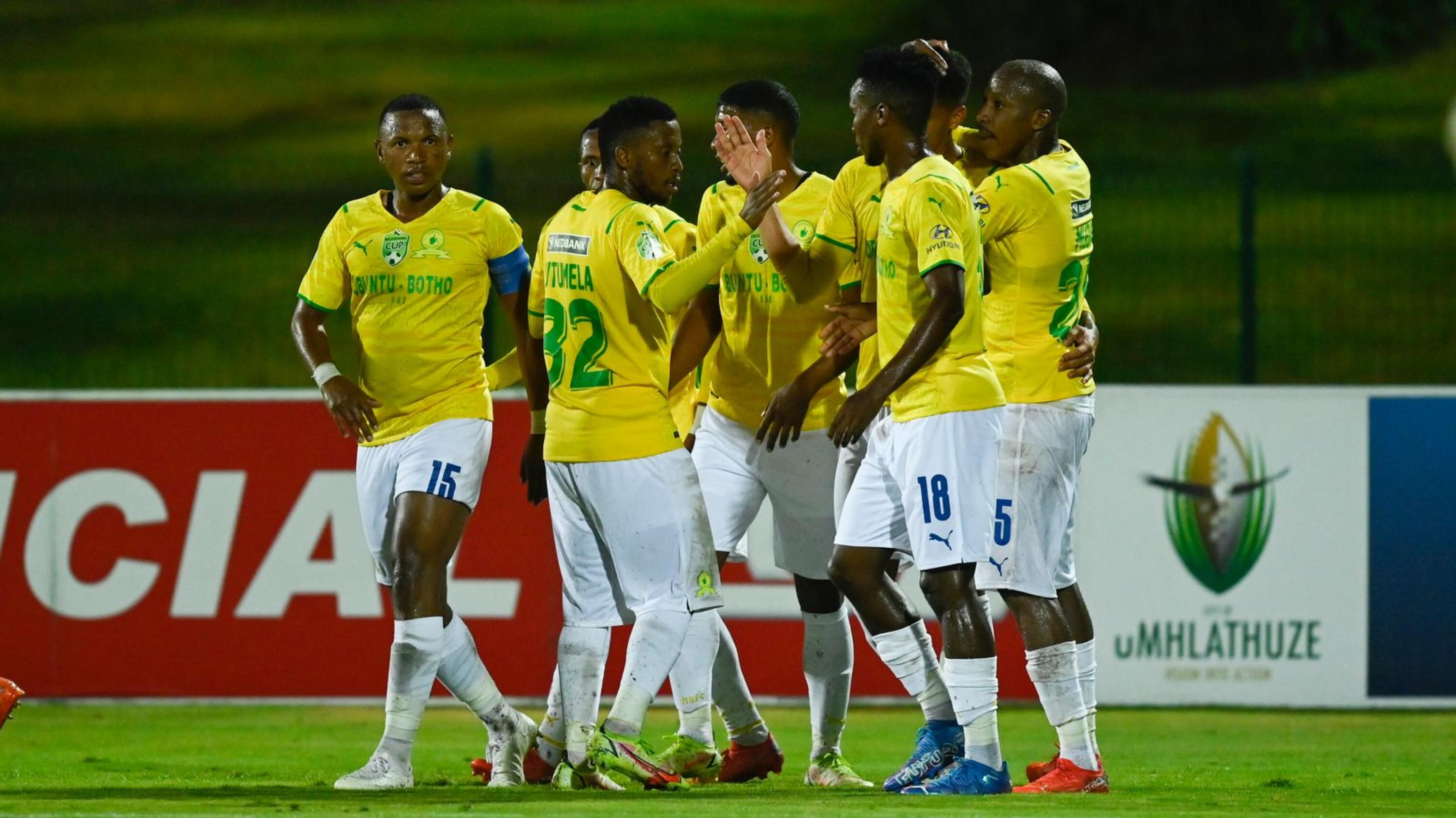 Mamelodi Sundowns players celebrate with defender Rushine de Reuck after he scored their second goal during their Nedbank Cup Last 32 game against Richards Bay at Princess Magogo Stadium in Durban on Friday