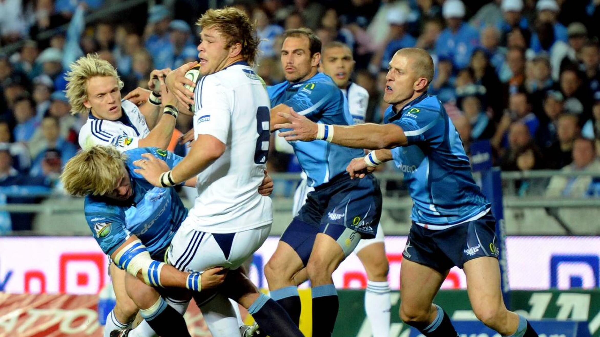 Duane Vermeulen is tackled by Wynand Olivier during the 2010 Super Rugby final at Orlando Stadium.