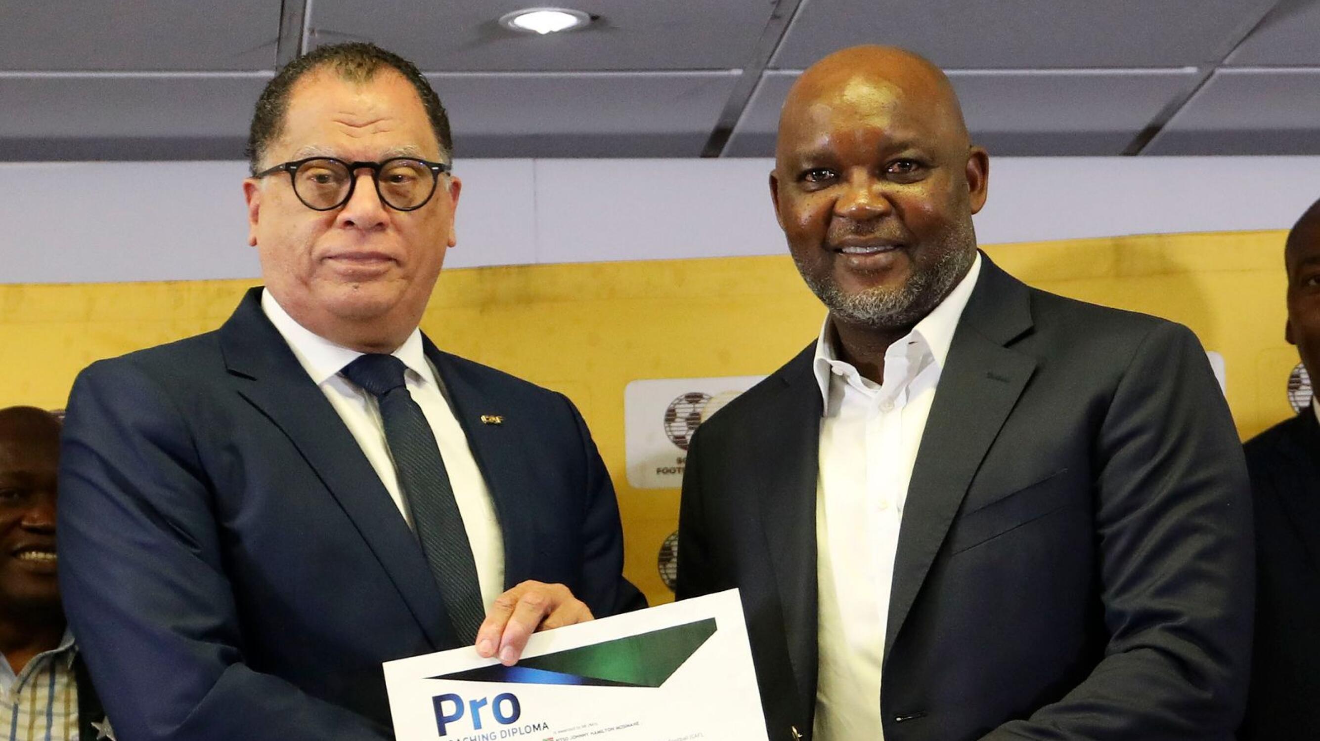 Pitso Mosimane receives a coaching CAF PRO licence from Safa president Danny Jordaan at the SAFA House in Johannesburg on Thursday