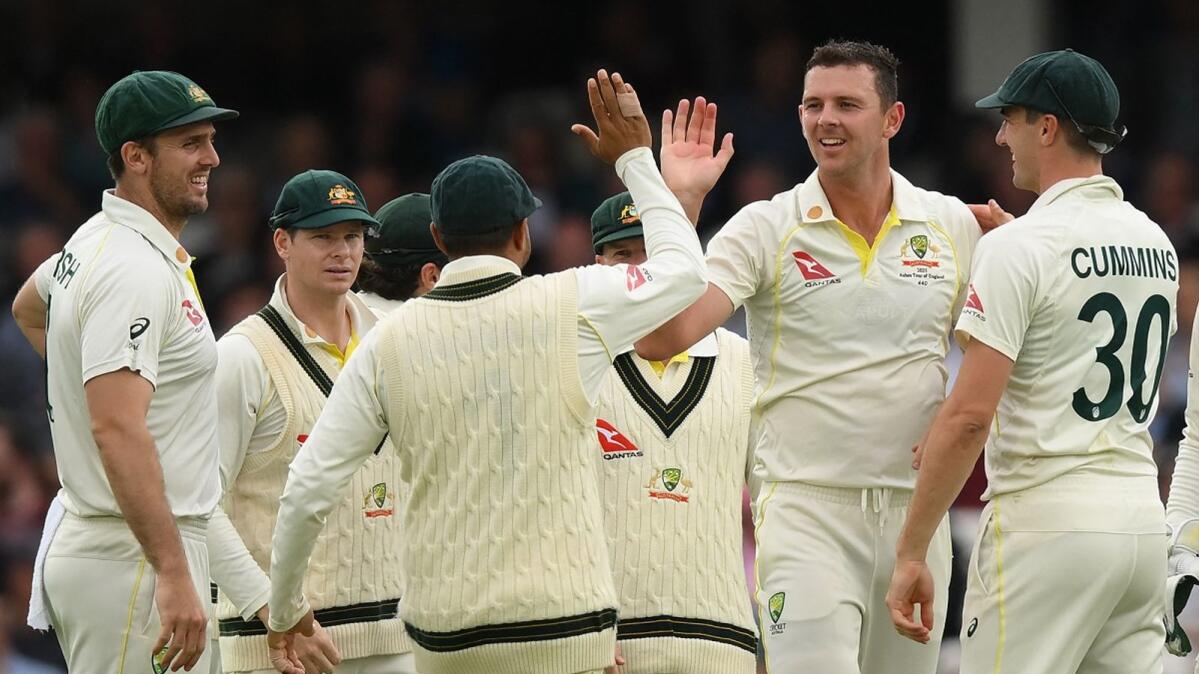 Australia's Josh Hazlewood celebrates with teammates after bowling England's Jonny Bairstow on the opening day of the fifth Ashes cricket Test match at The Oval cricket ground in London on Thursday