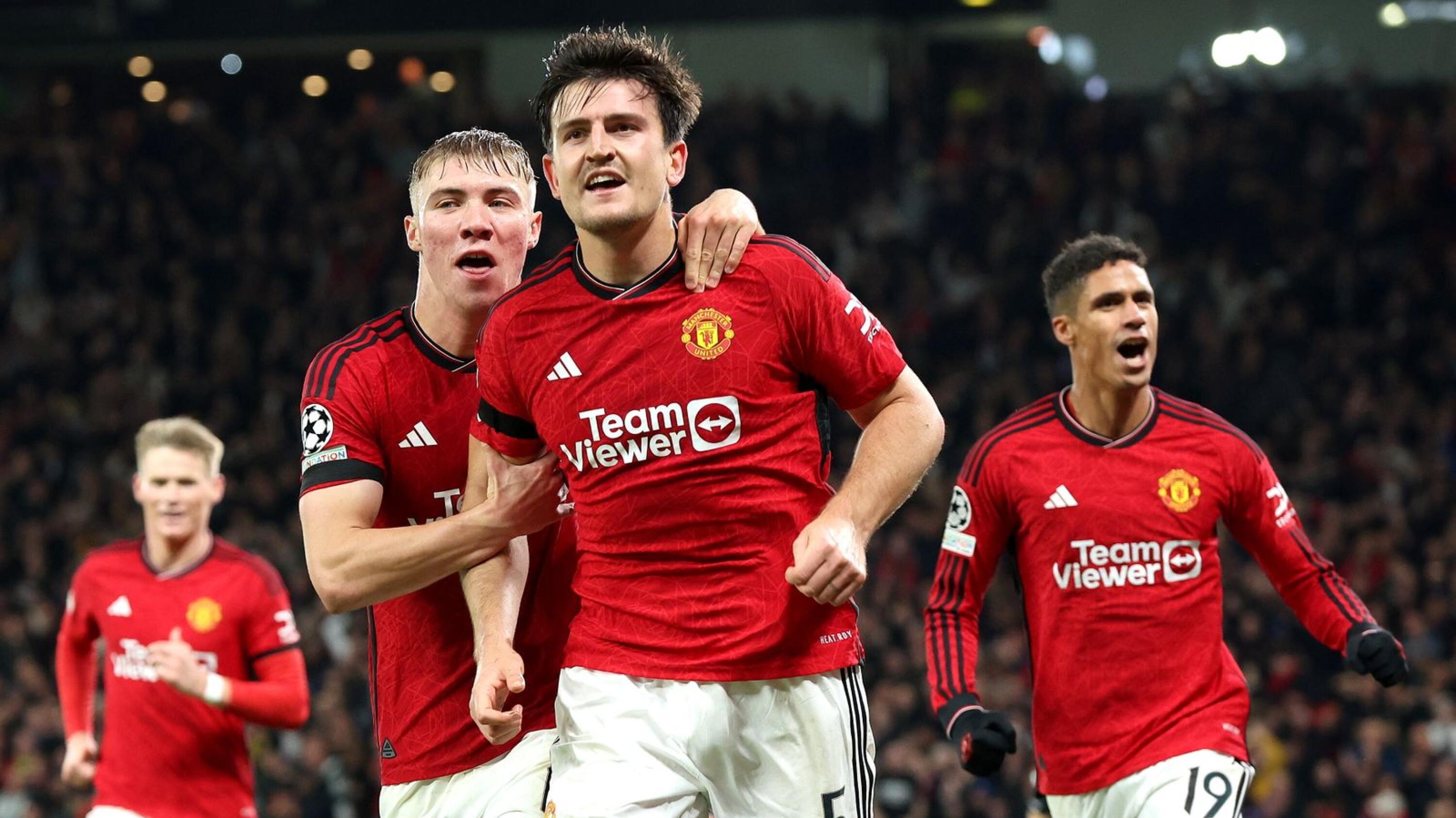 Harry Maguire (C) of Manchester United celebrates with teammate Rasmus Hojlund after scoring the opening goal during t
