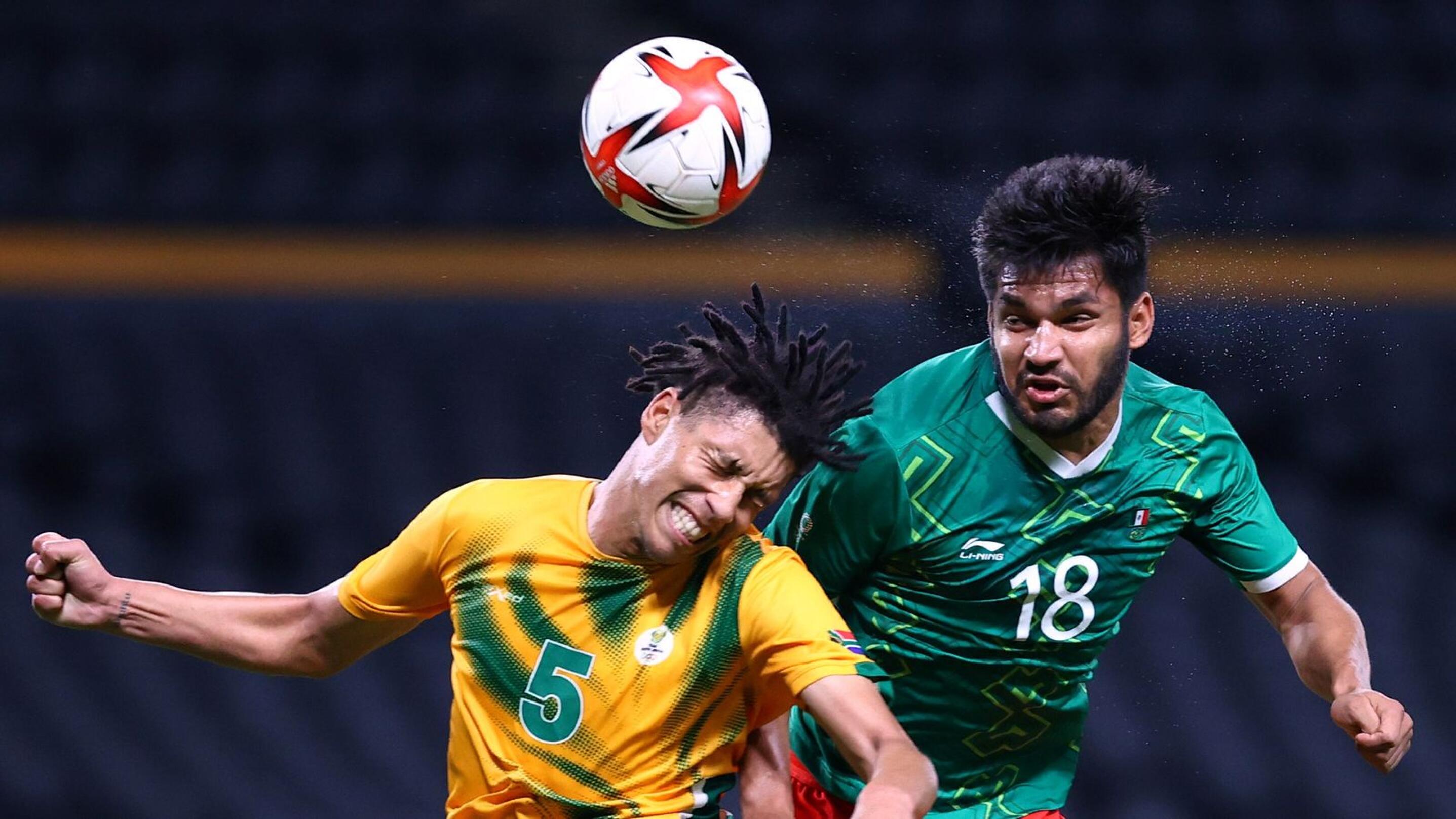 Luke Fleurs of South Africa in action with Eduardo Aguirre of Mexico during their Olympic Group A game on Wedensday